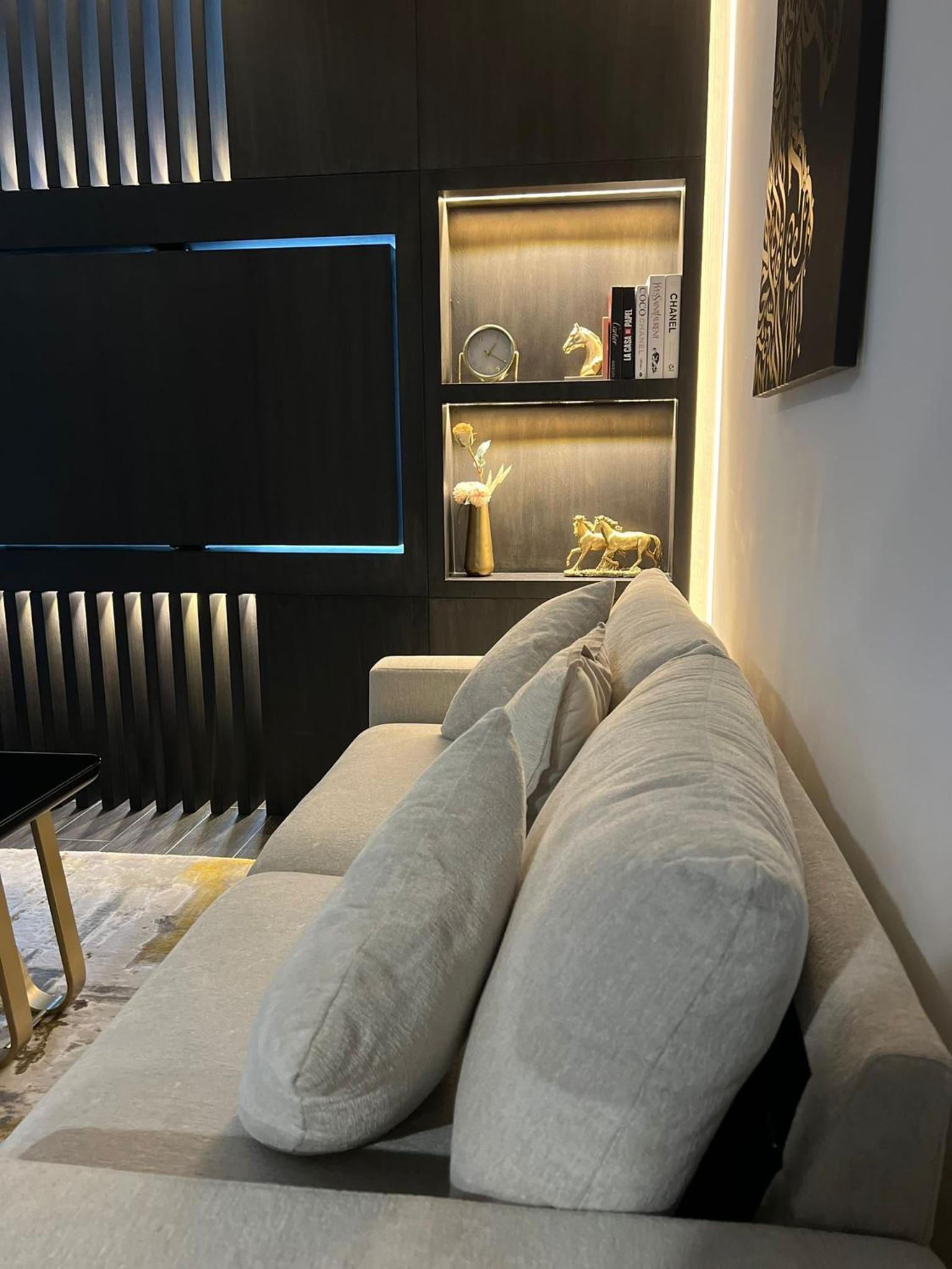 a row of pillows on a bed in a room at Harbor Row in Manama