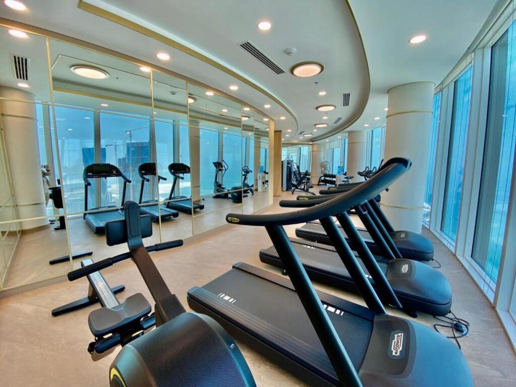 a gym with a bunch of treadmills in it at TOP Luxurious and Cozy 2BR with 5 mins to Bahrain Bay in Manama