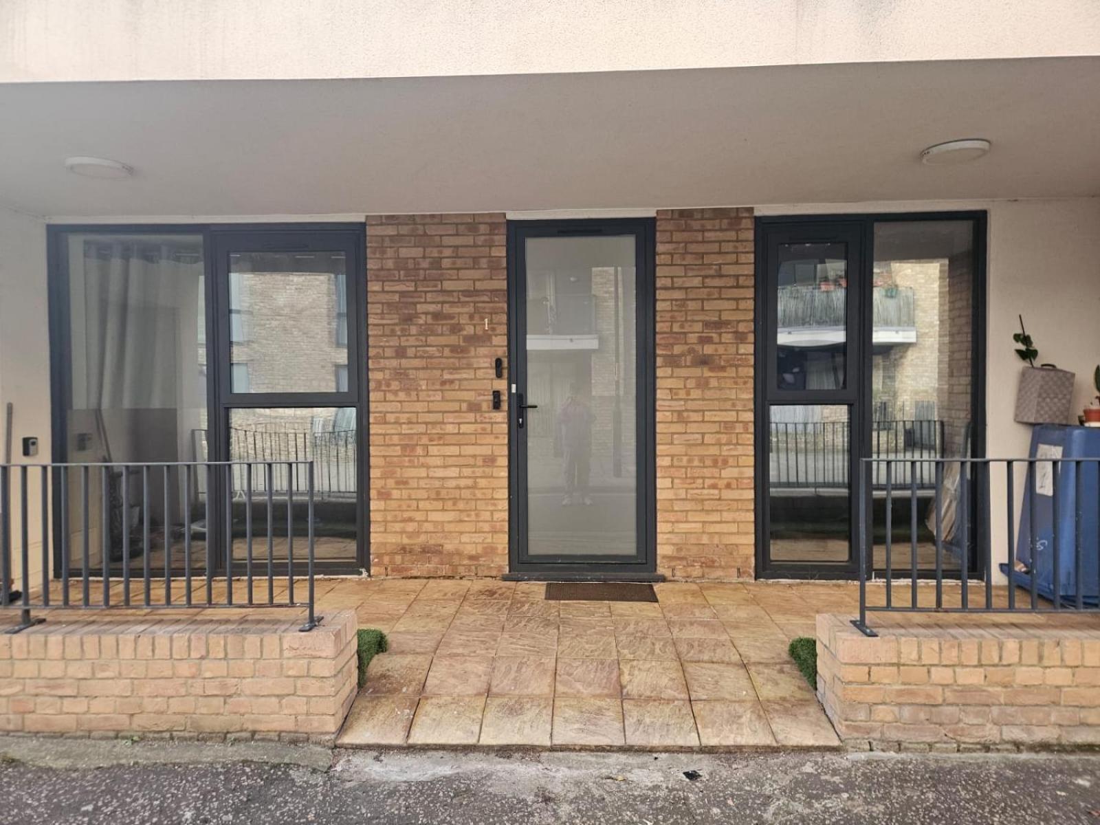 a building with glass doors on the side of it at Modern Apartment Central London in London
