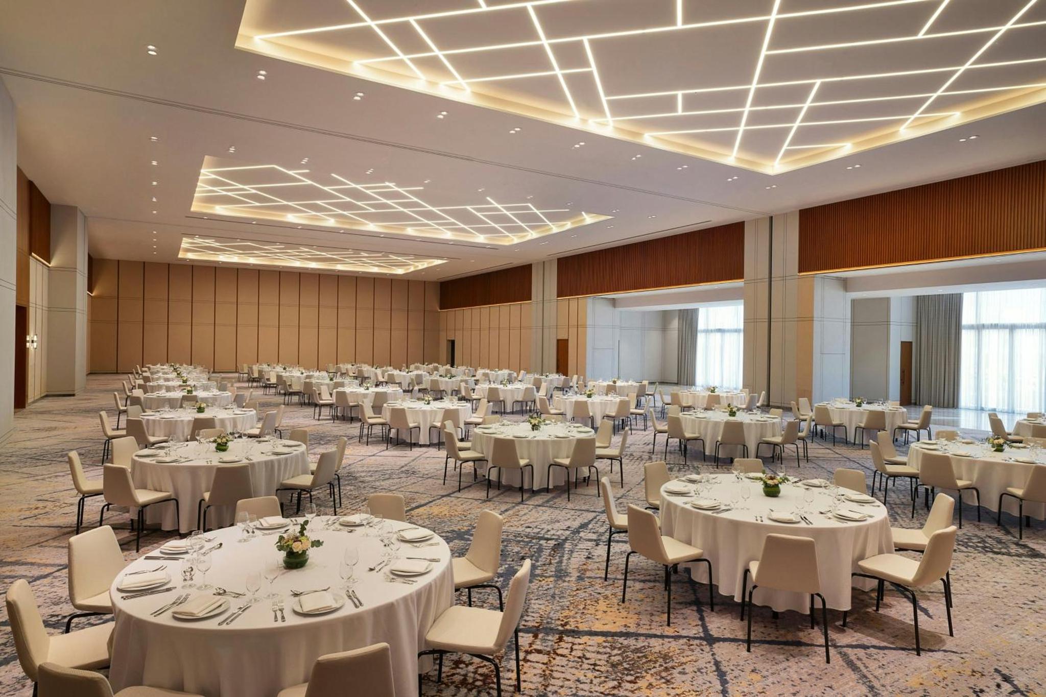 a banquet hall with white tables and chairs at Sheraton Bahrain Hotel in Manama +88 photos