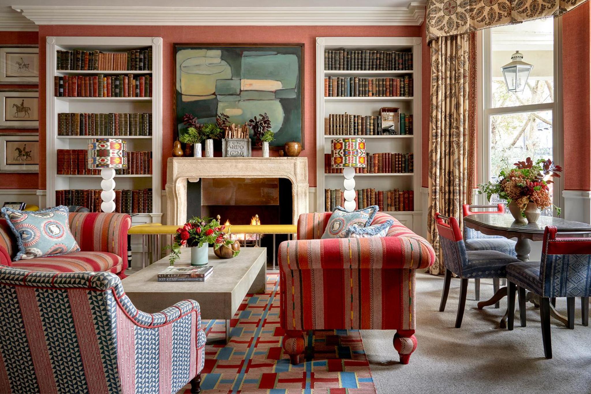 a living room with two chairs and a fireplace at Knightsbridge Hotel, Firmdale Hotels in London