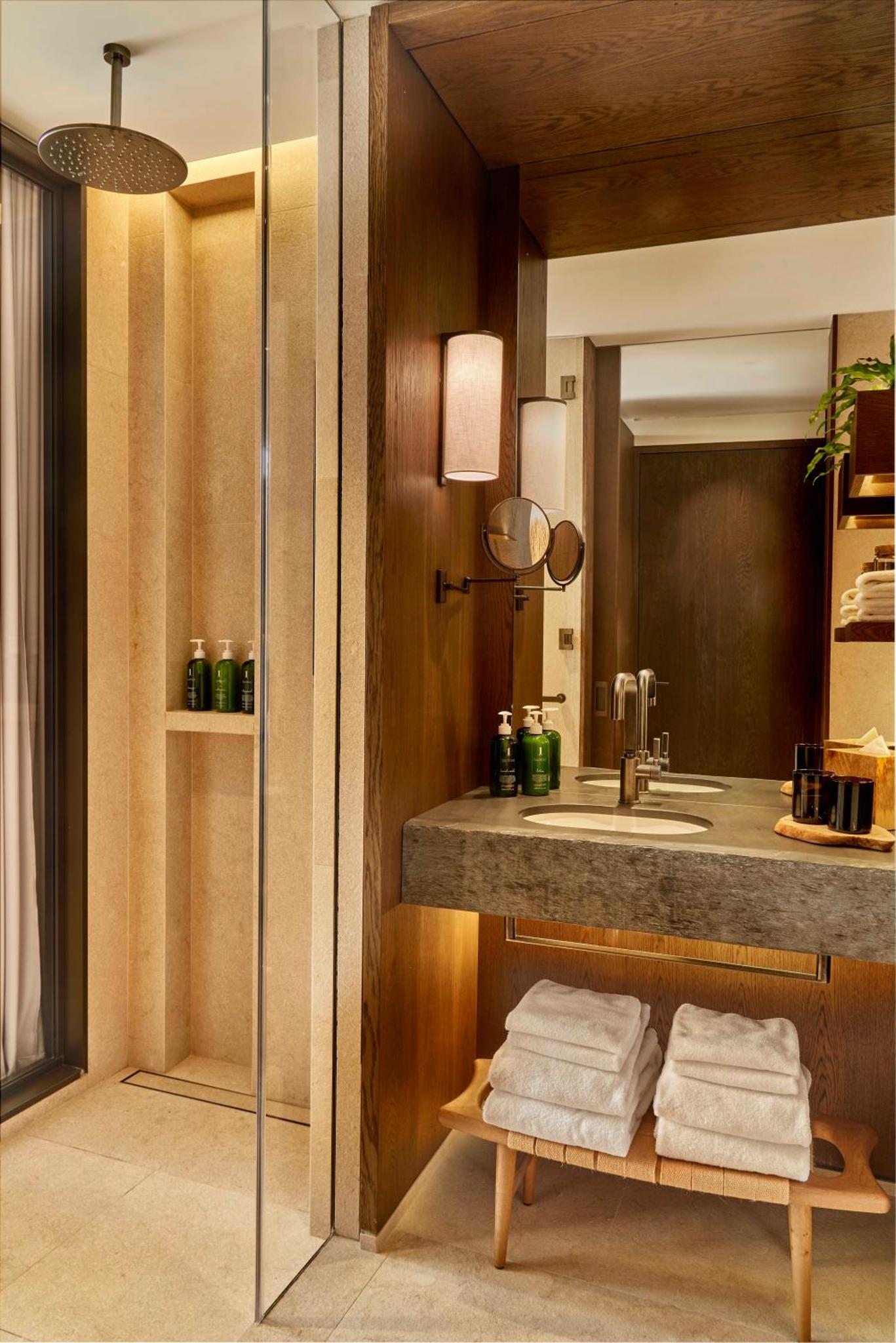 a bathroom with a sink and a counter with towels at 1 Hotel Mayfair in London