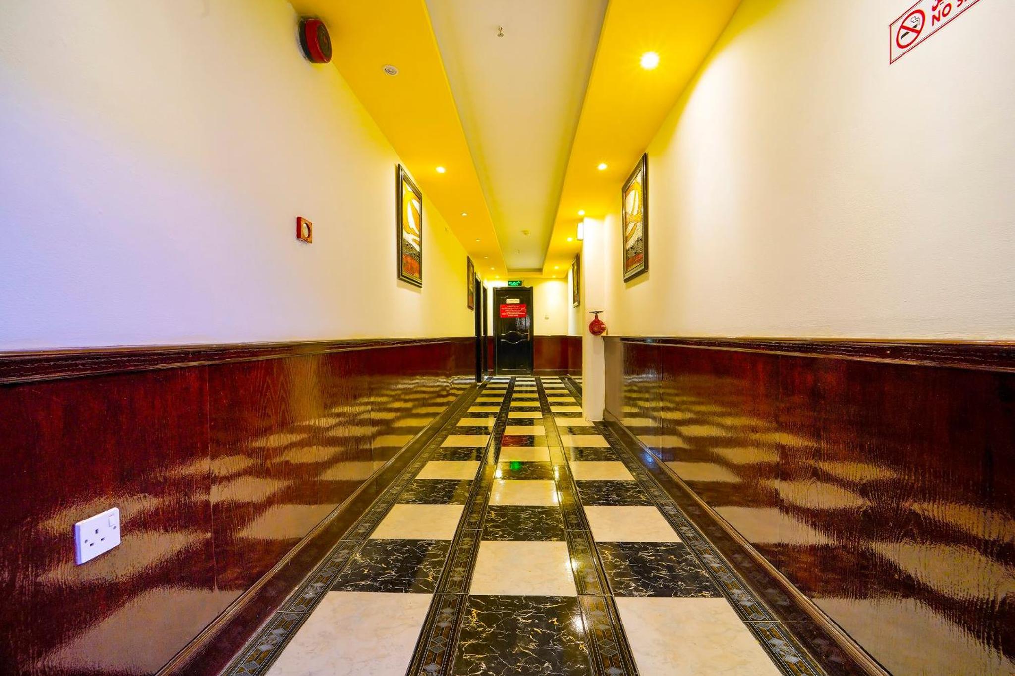 a hallway with a checkered floor in a building at OYO 124 Al Salam Palace Hotel in Manama +19 photos