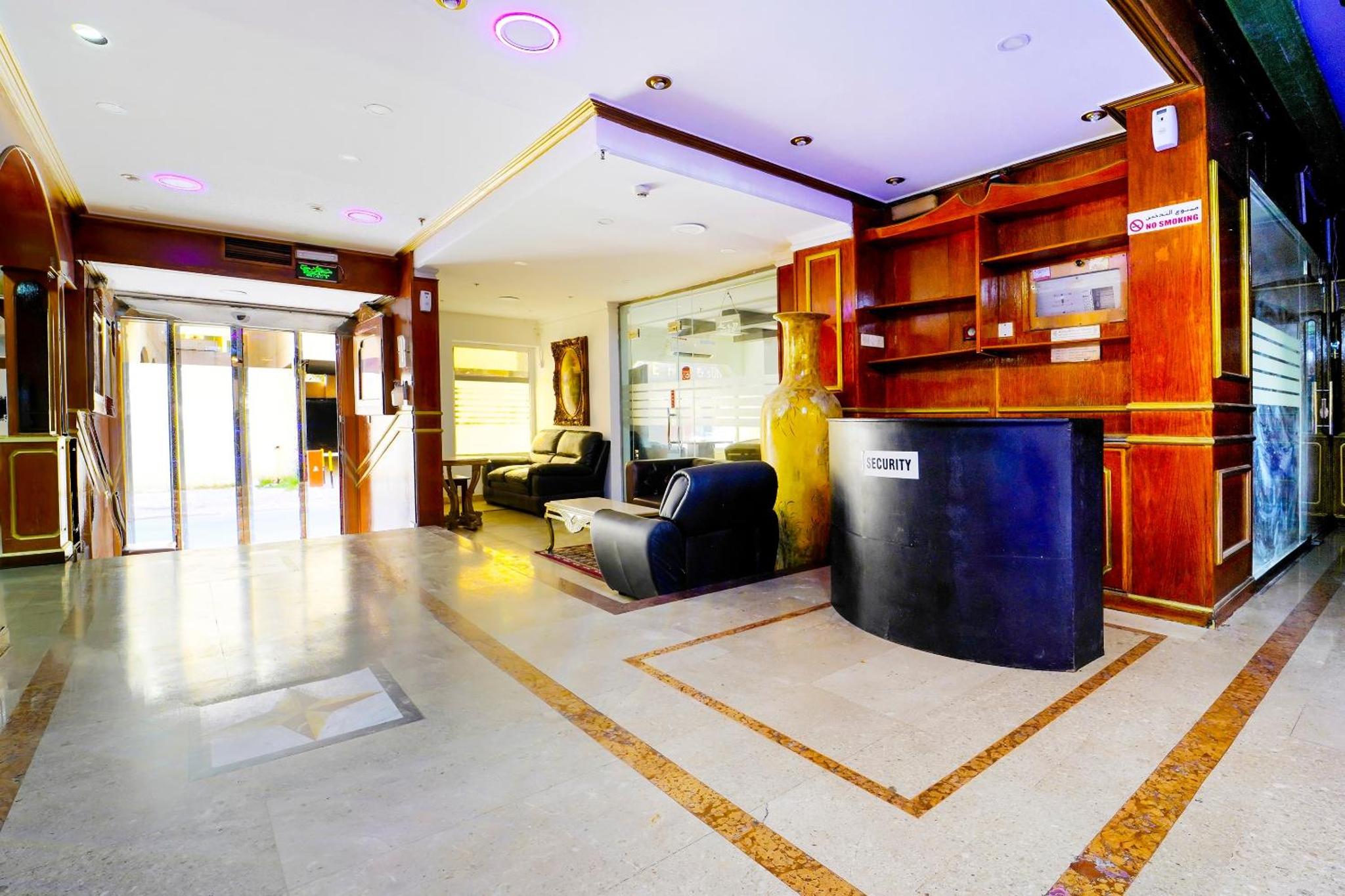 a lobby with a bar in a building at OYO 124 Al Salam Palace Hotel in Manama