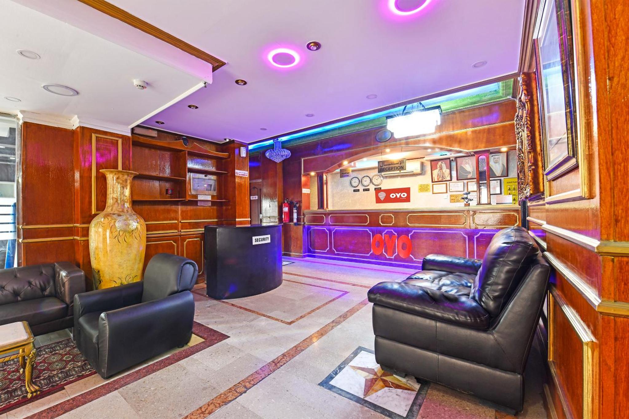 a room with leather chairs and a bar at OYO 124 Al Salam Palace Hotel in Manama