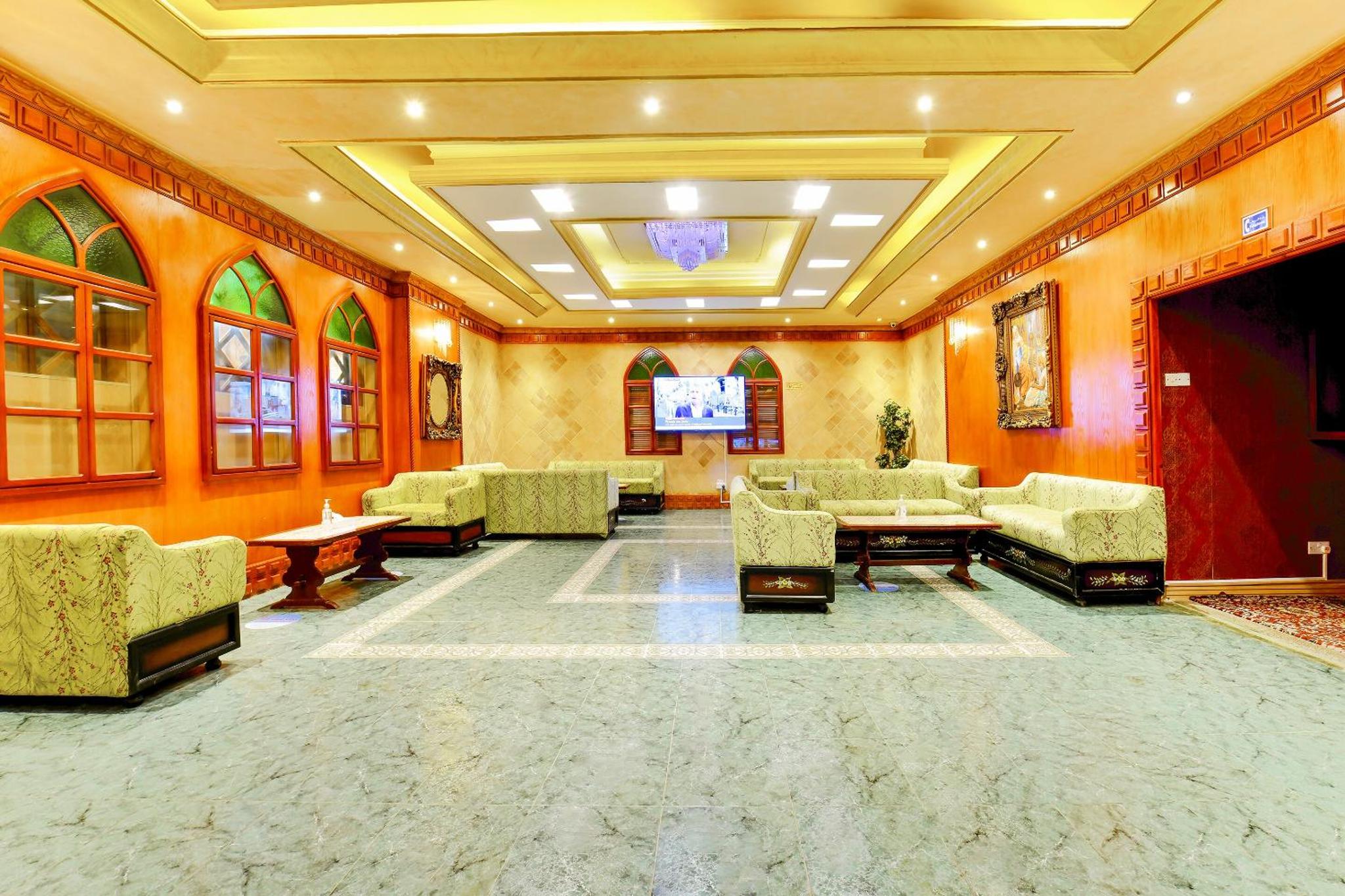 a large lobby with couches and a tv in it at Capital O 125 Moon Plaza Hotel in Manama