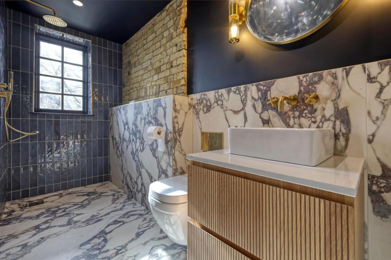 a bathroom with a sink and a toilet at The Carlton Tavern Hotel in London