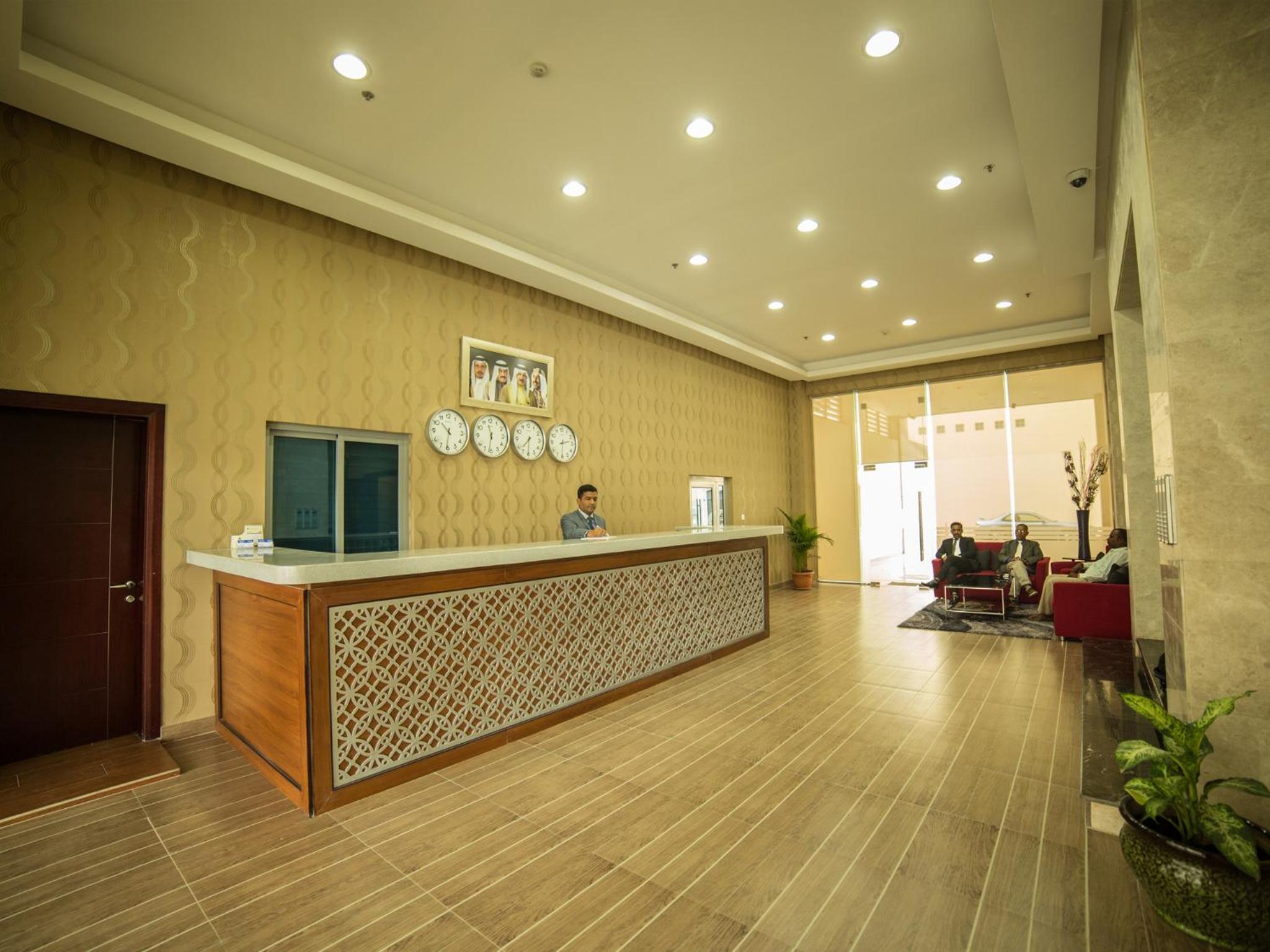 a lobby with a reception desk and people in a room at Golden Rose Luxury Suites (Royal Executive) in Manama +65 photos