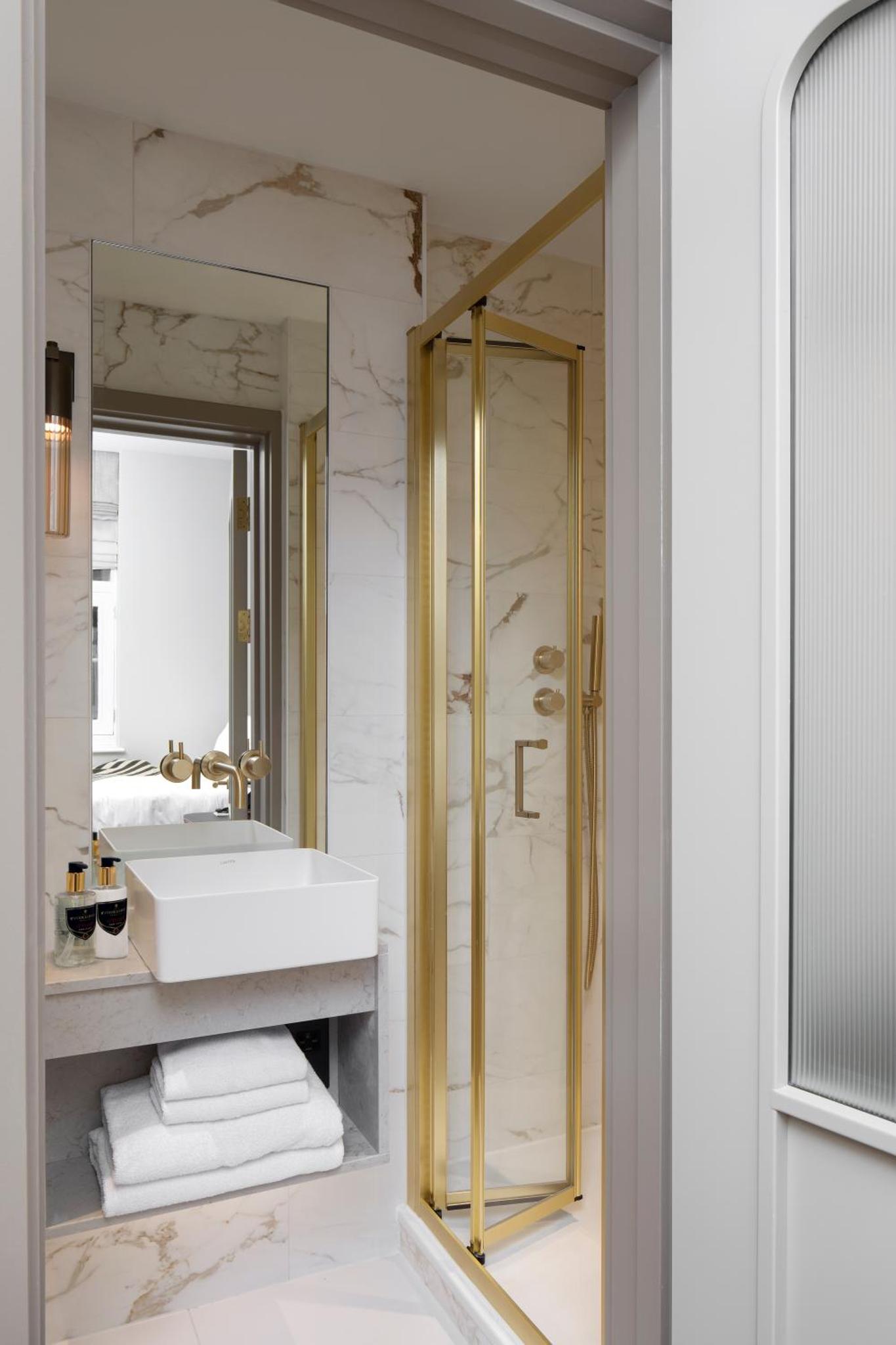 a bathroom with a white sink and a mirror at Montcalm Mayfair Townhouse in London