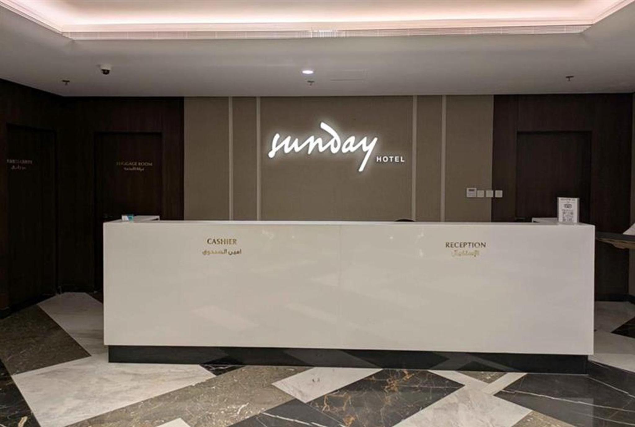 a white counter in a room with a sign on a wall at Sunday Luxury Downtown Adliya Formerly Jewel Hotel in Manama