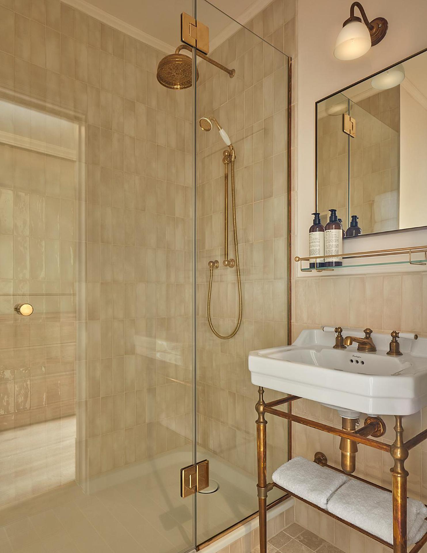 a bathroom with a sink and a shower at Miiro Templeton Garden in London