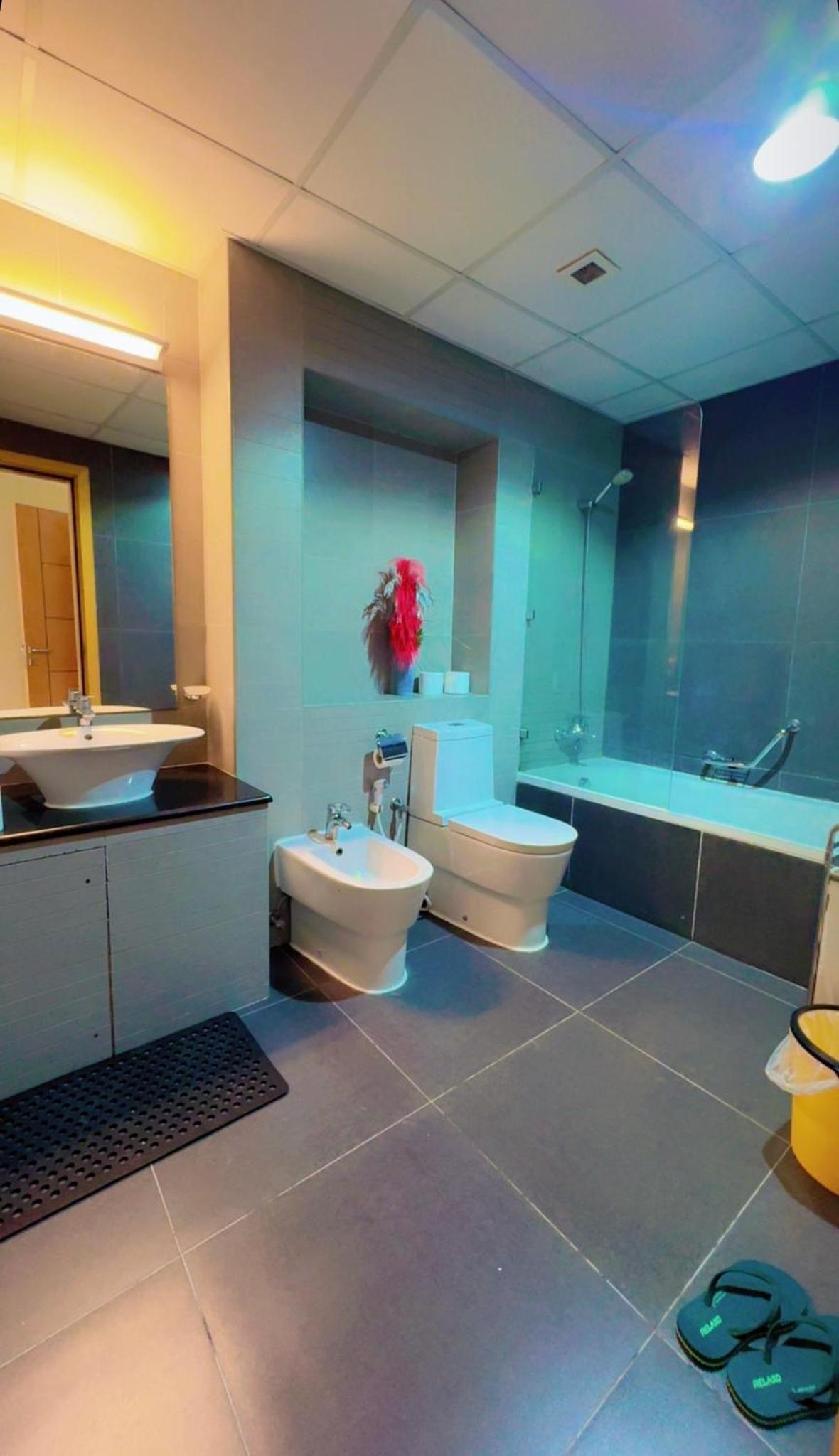 a bathroom with two sinks and a toilet and a tub at شقة خاصة in Muharraq