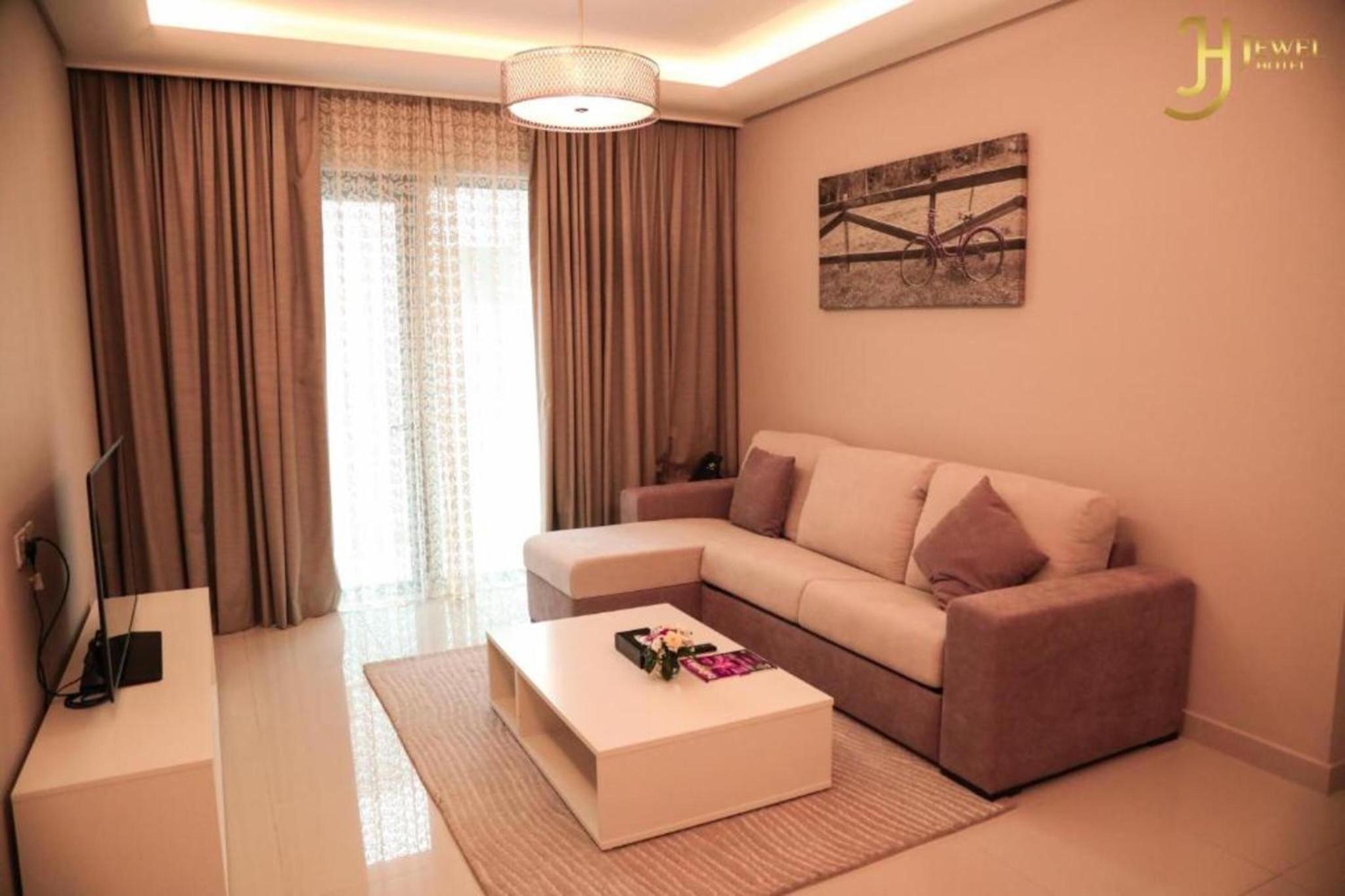 a living room with a couch and a coffee table at Dancenter Jewel Near World Trade Center in Manama