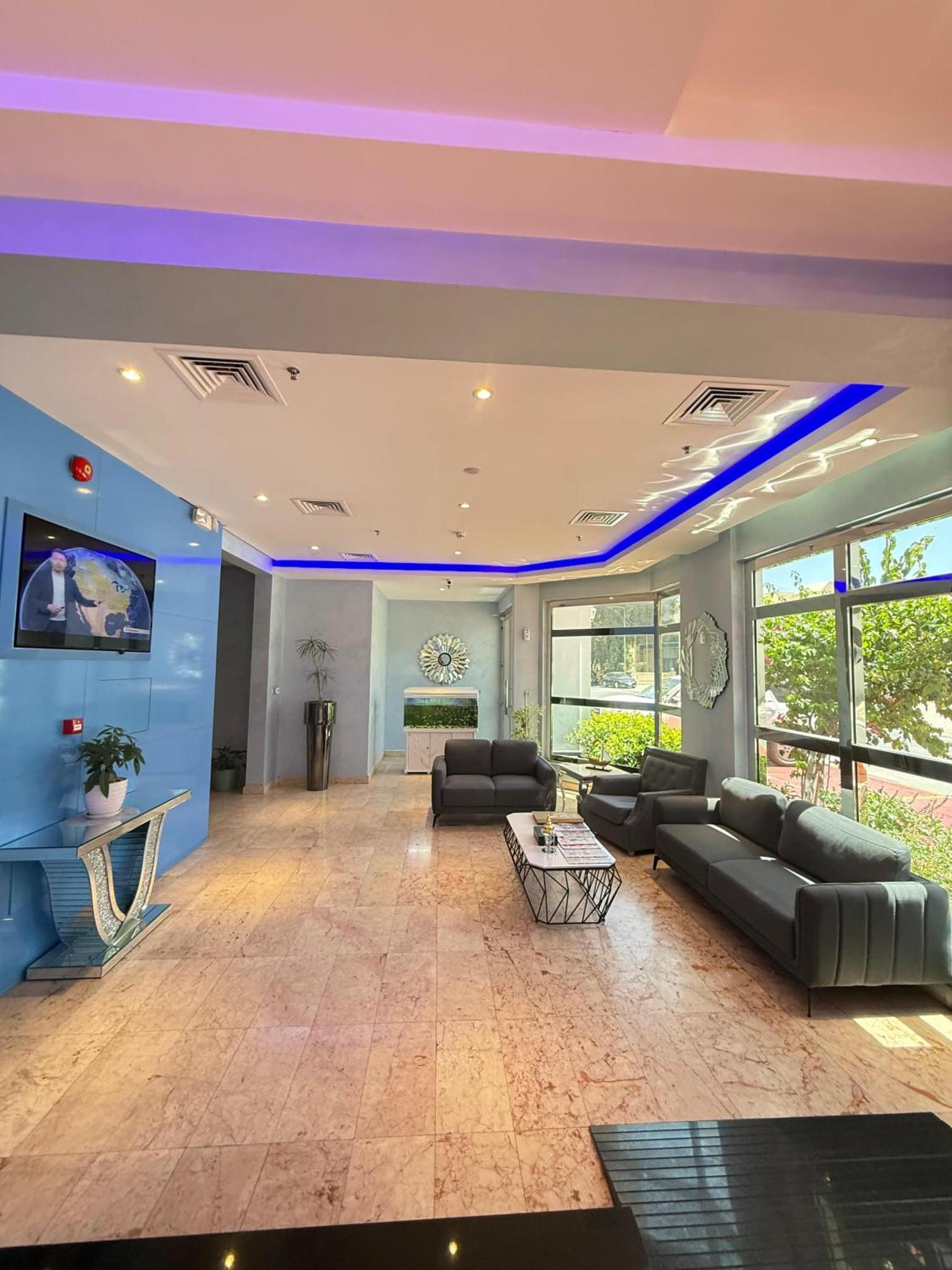 a large living room with a purple ceiling at Swan Towers Juffair in Manama