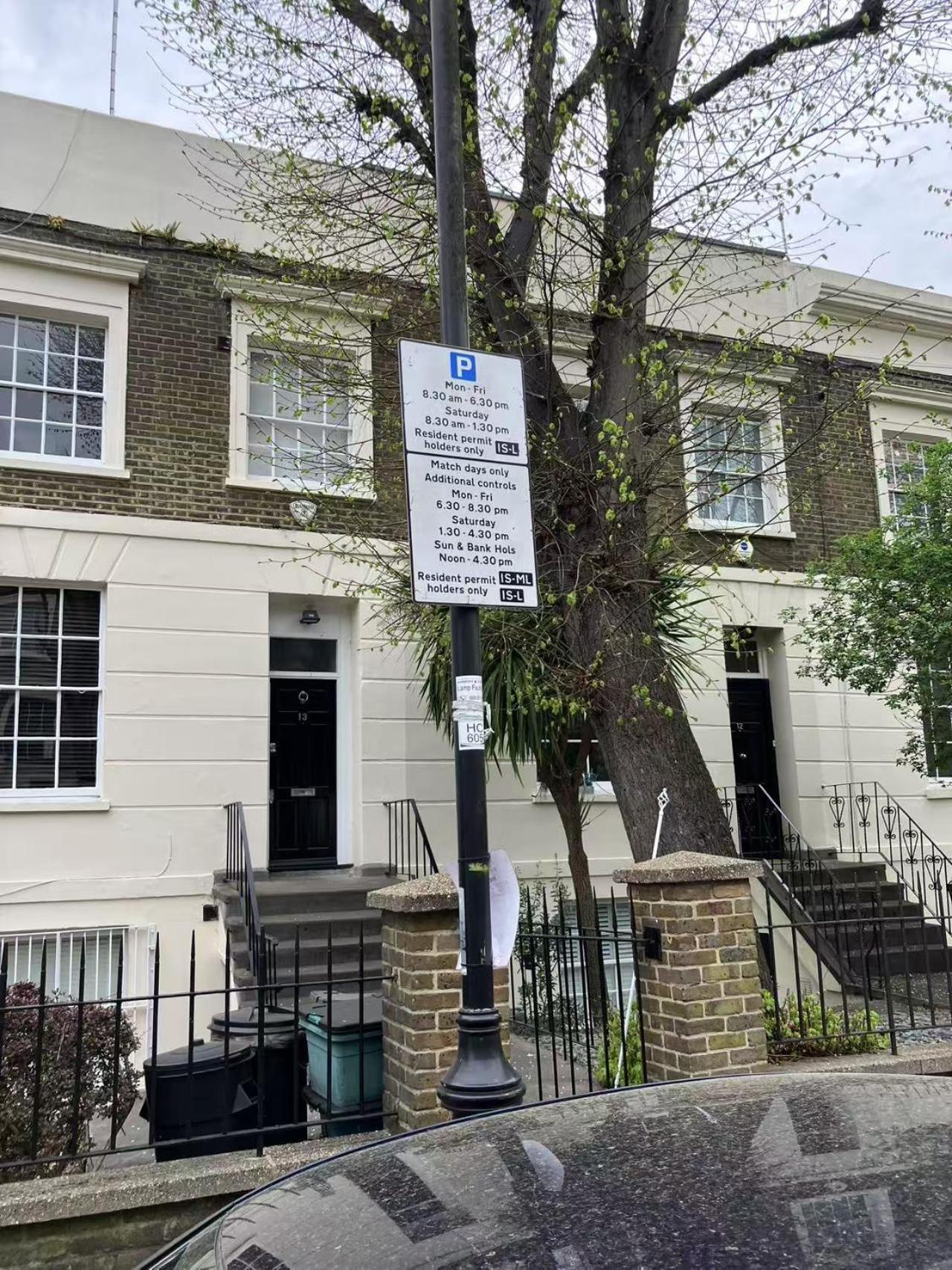 a sign on a pole in front of a building at Large, quiet flat in Islington in London