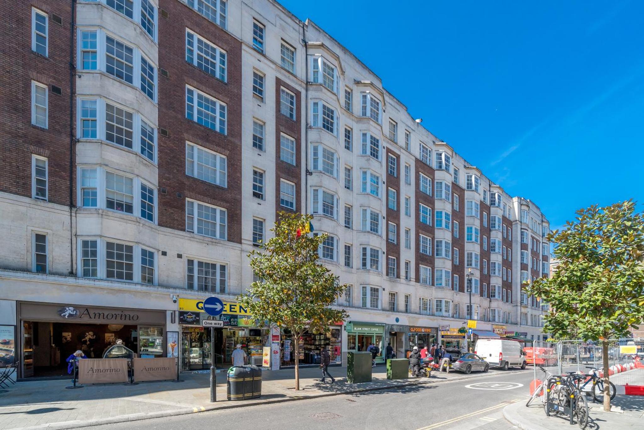 a large brick building on a city street at Elegant 4 Bed Flat Opposite Hyde Park in London
