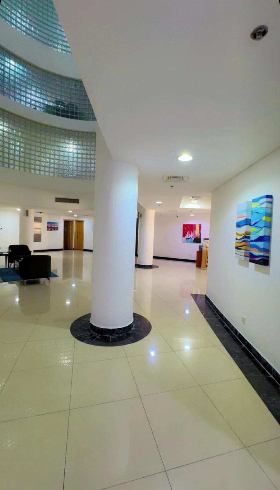 an empty lobby with a column in a building at شقة خاصة in Muharraq +31 photos