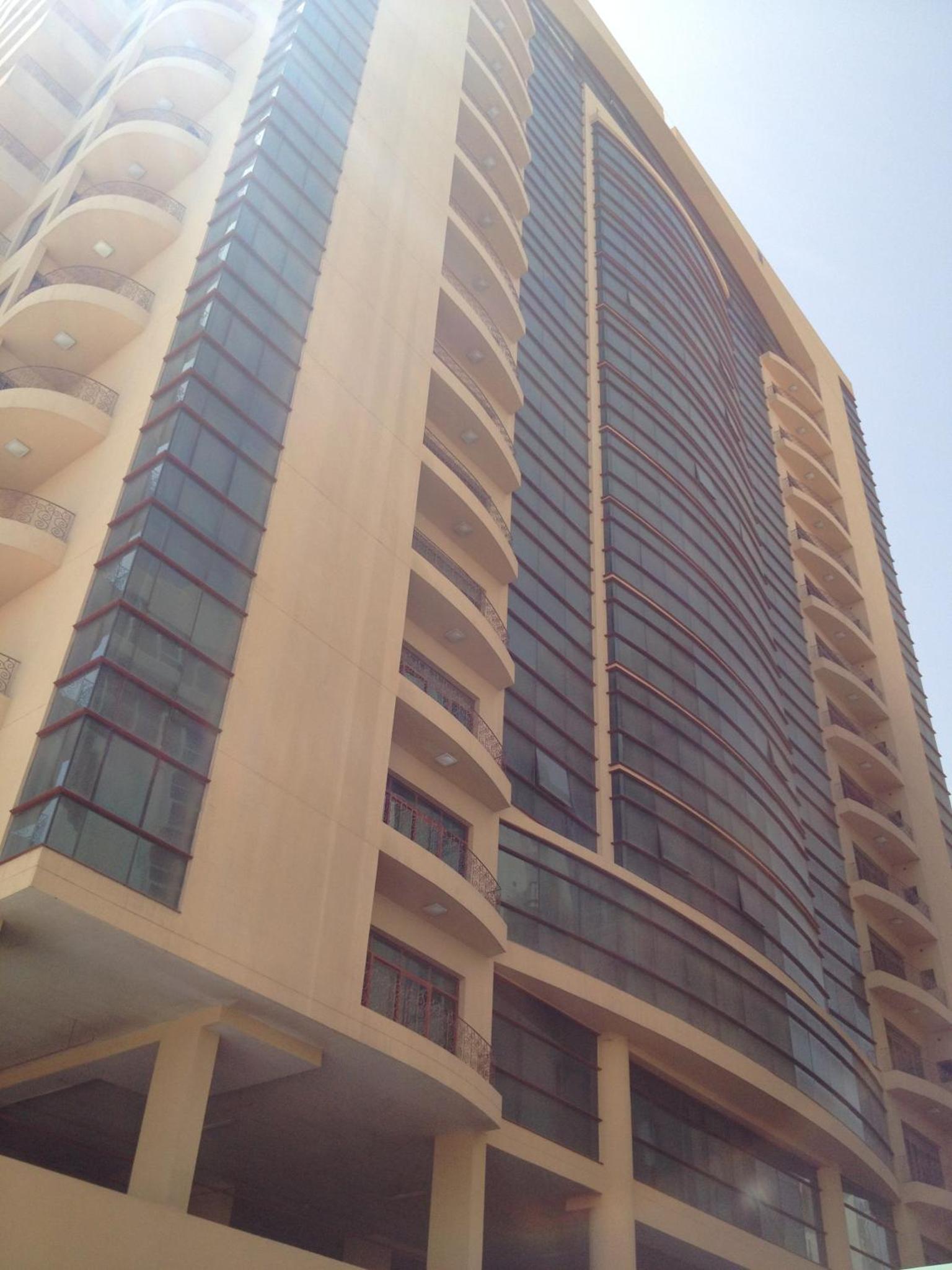a tall building with a lot of windows at Al Manzil Hotel Bahrain in Juffair