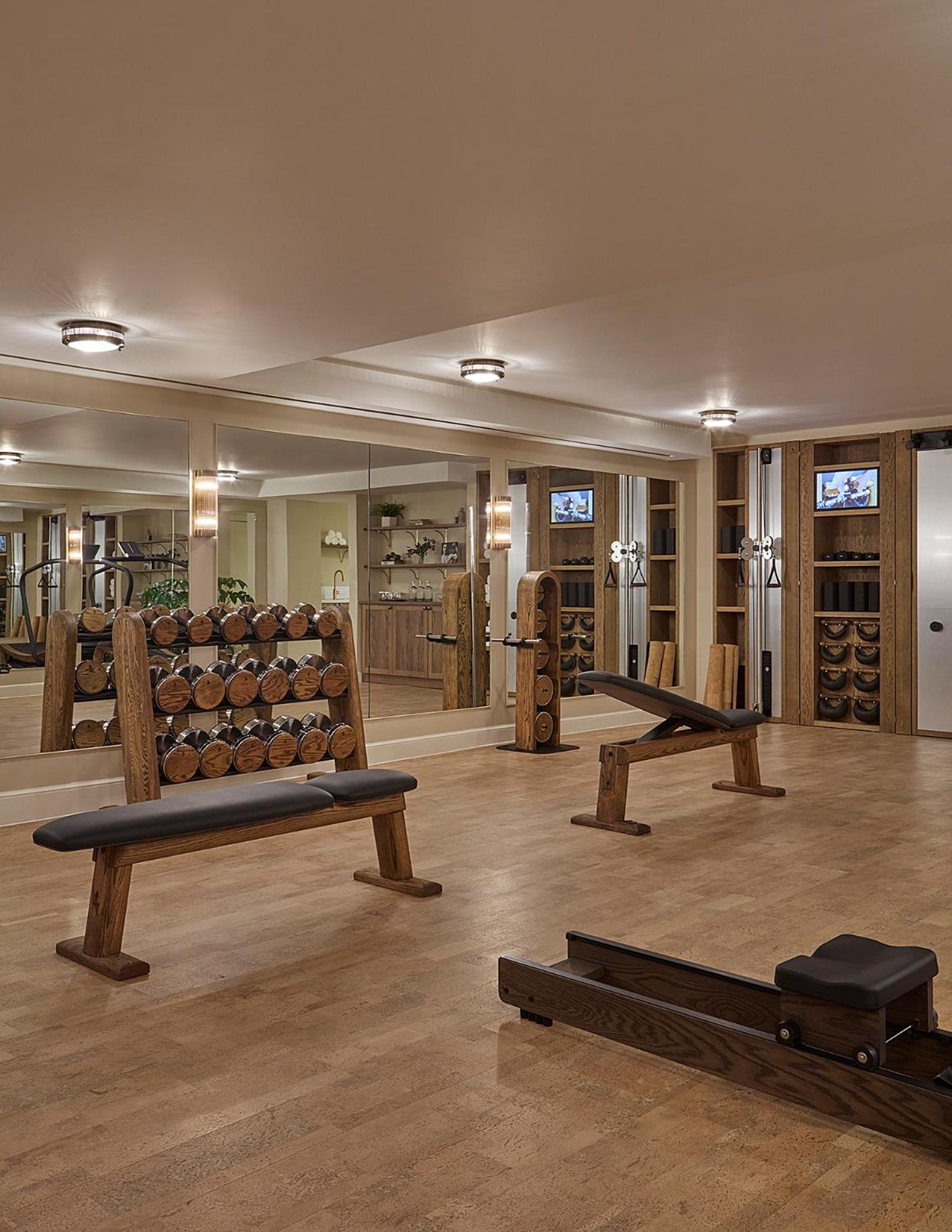 a large room with a gym with a lot of logs at Miiro Templeton Garden in London