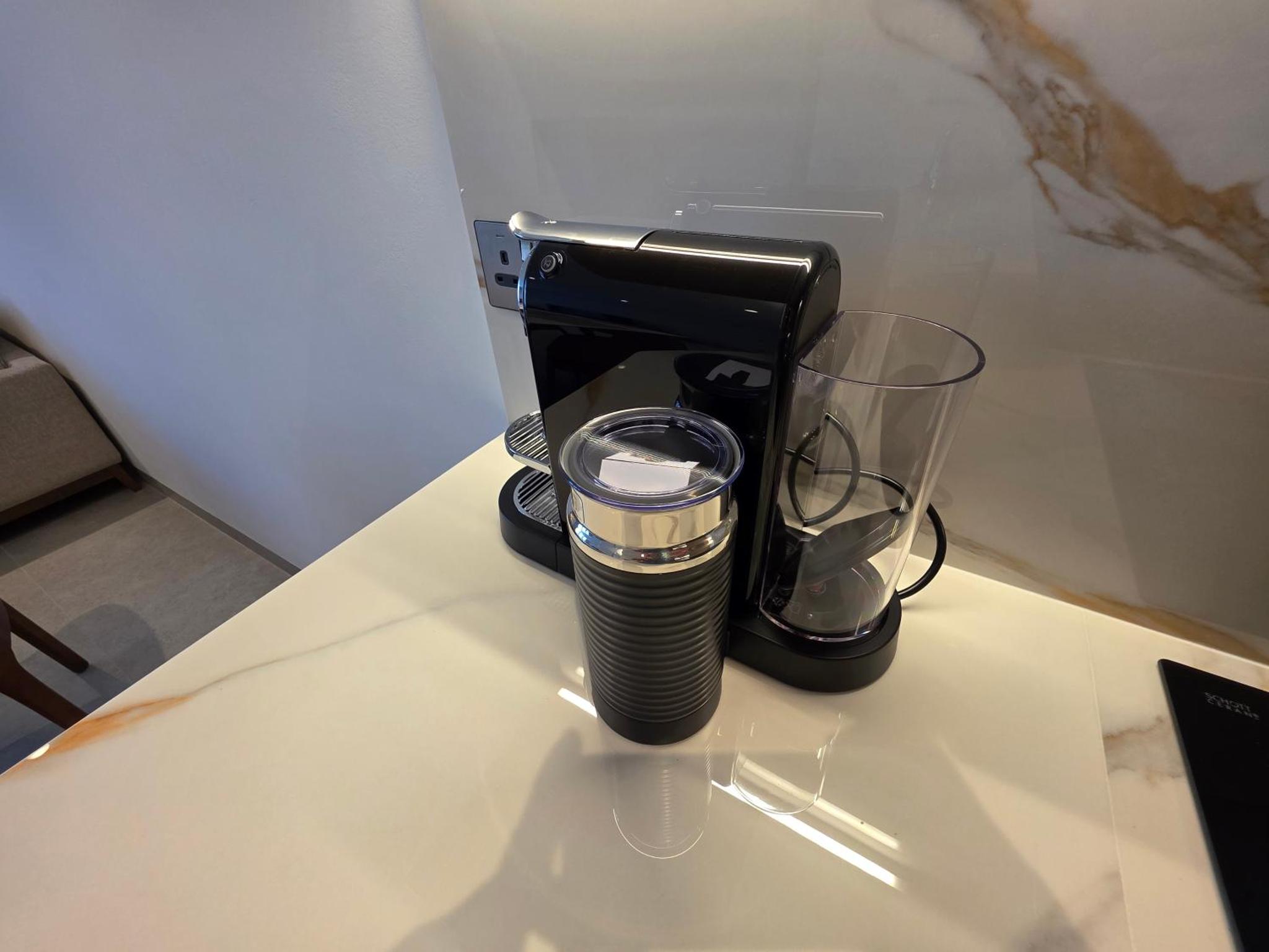 a black coffee maker sitting on a table at Elegant 1BR with Balcony PearlHouse Luxury Living! in Manama