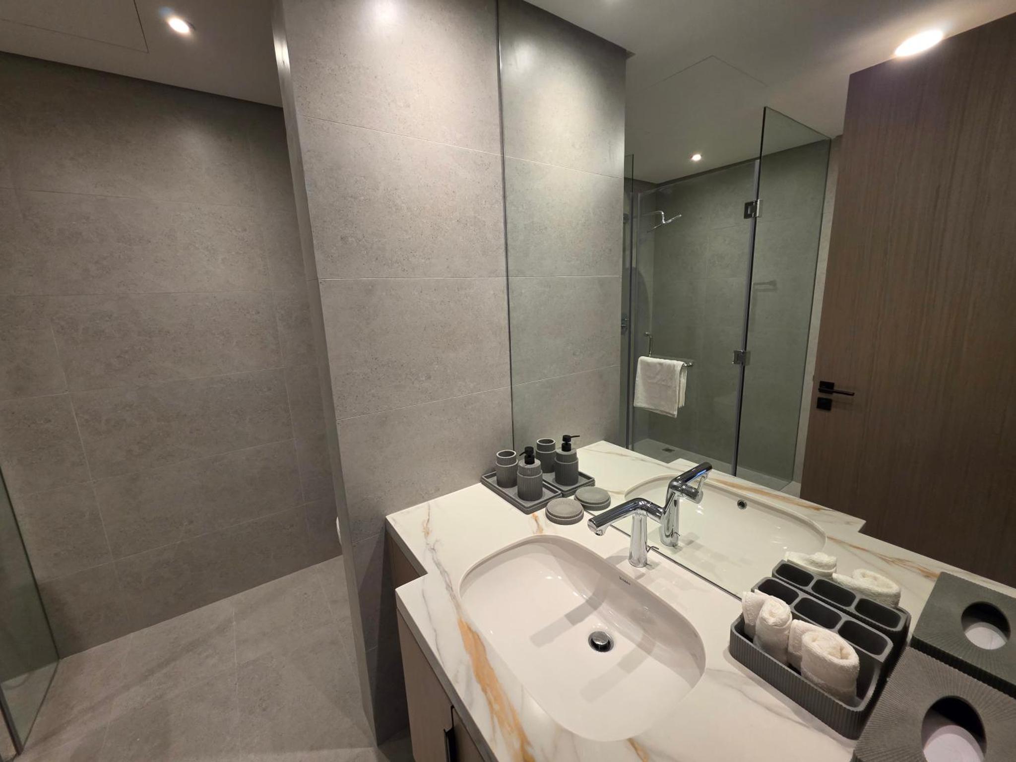 a bathroom with a sink and a mirror at Elegant 1BR with Balcony PearlHouse Luxury Living! in Manama