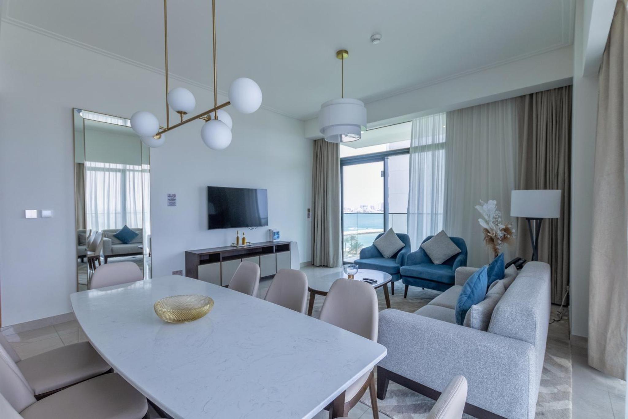 a living room with a white table and chairs at Premium Apartments at Address Resort Residendtial Building in Muharraq