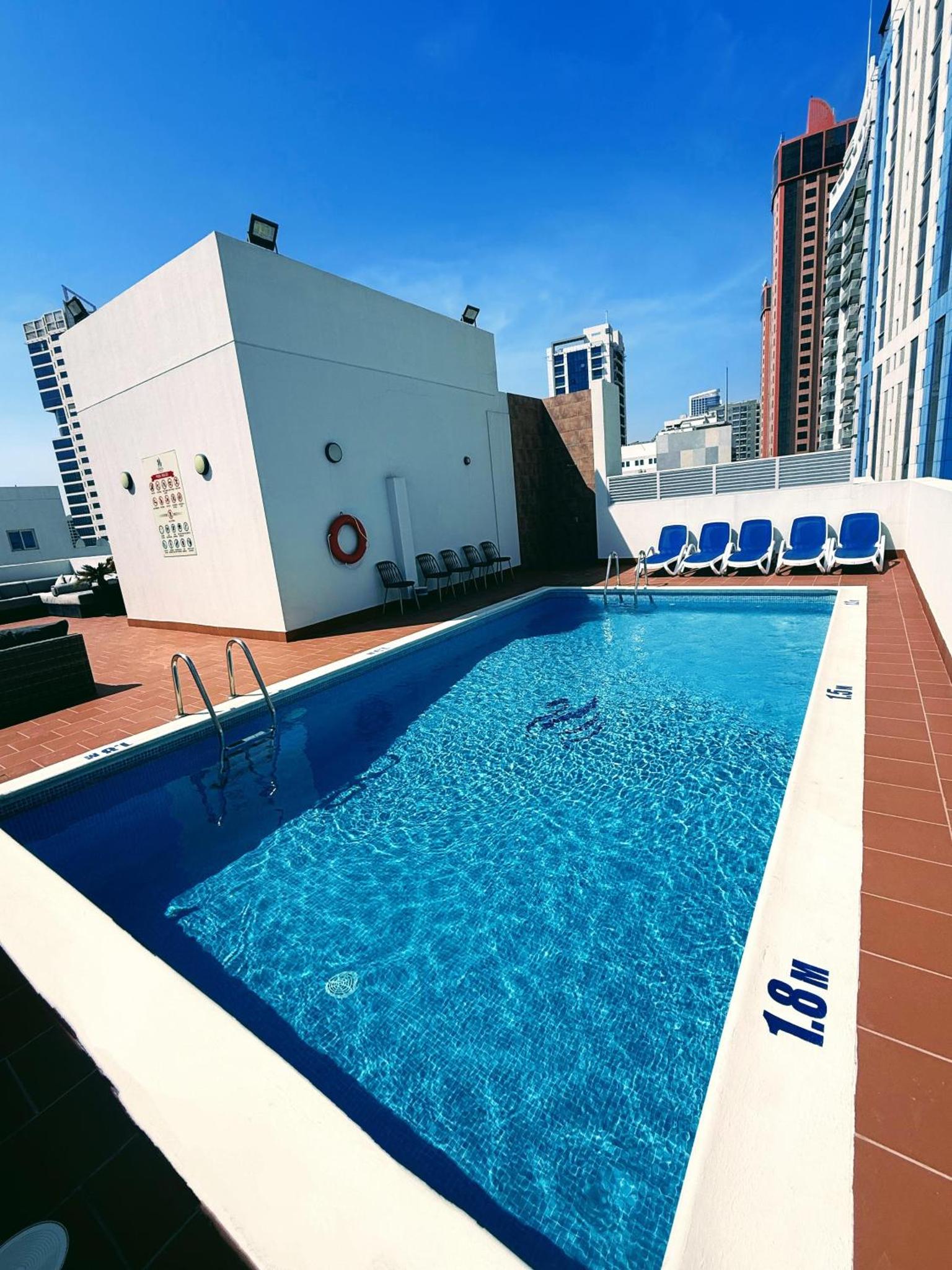 a swimming pool on the roof of a building at Swan Towers Juffair in Manama