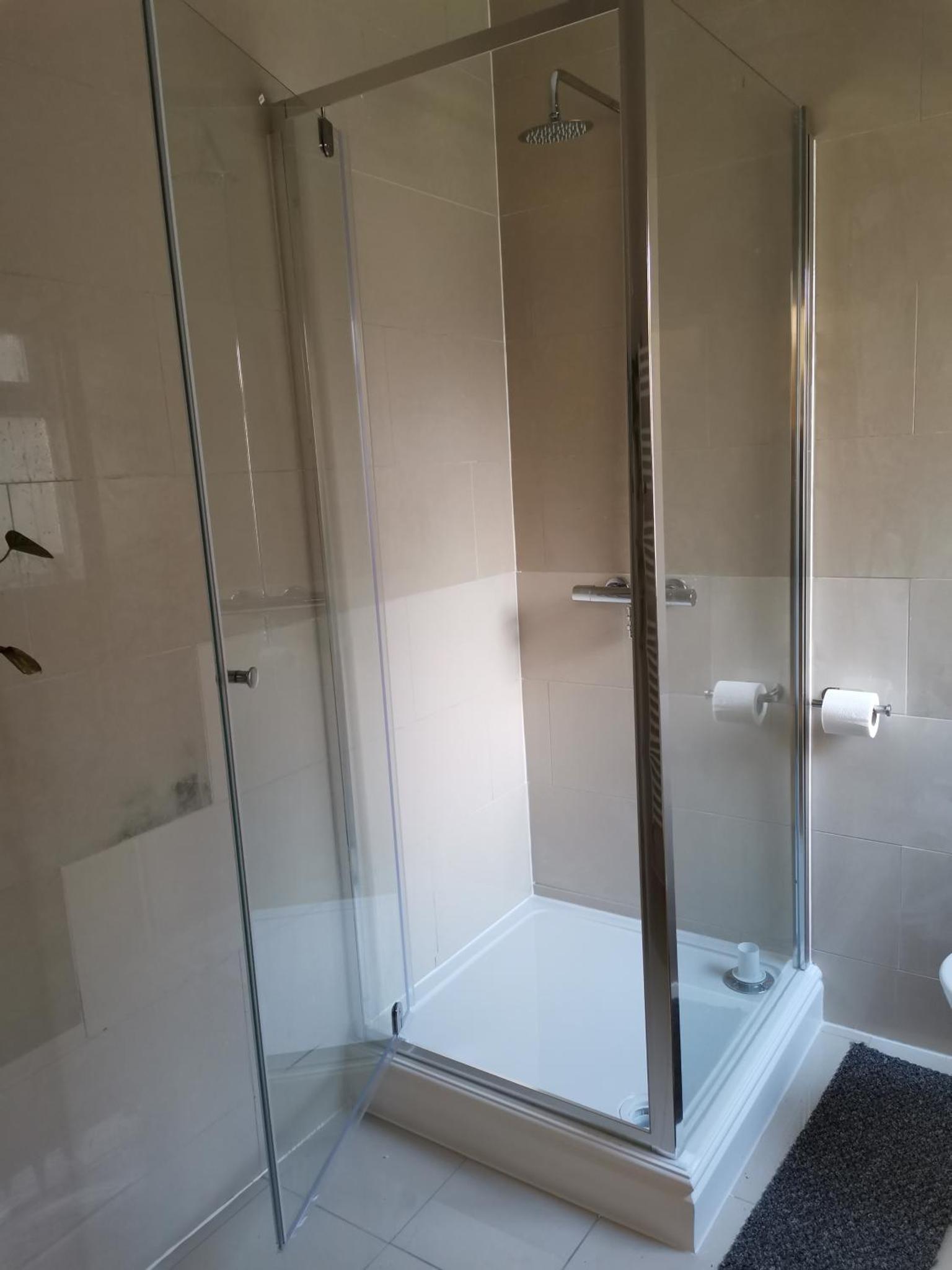 a shower with a glass door in a bathroom at Ax 1 Bed and Breakfast in London +44 photos