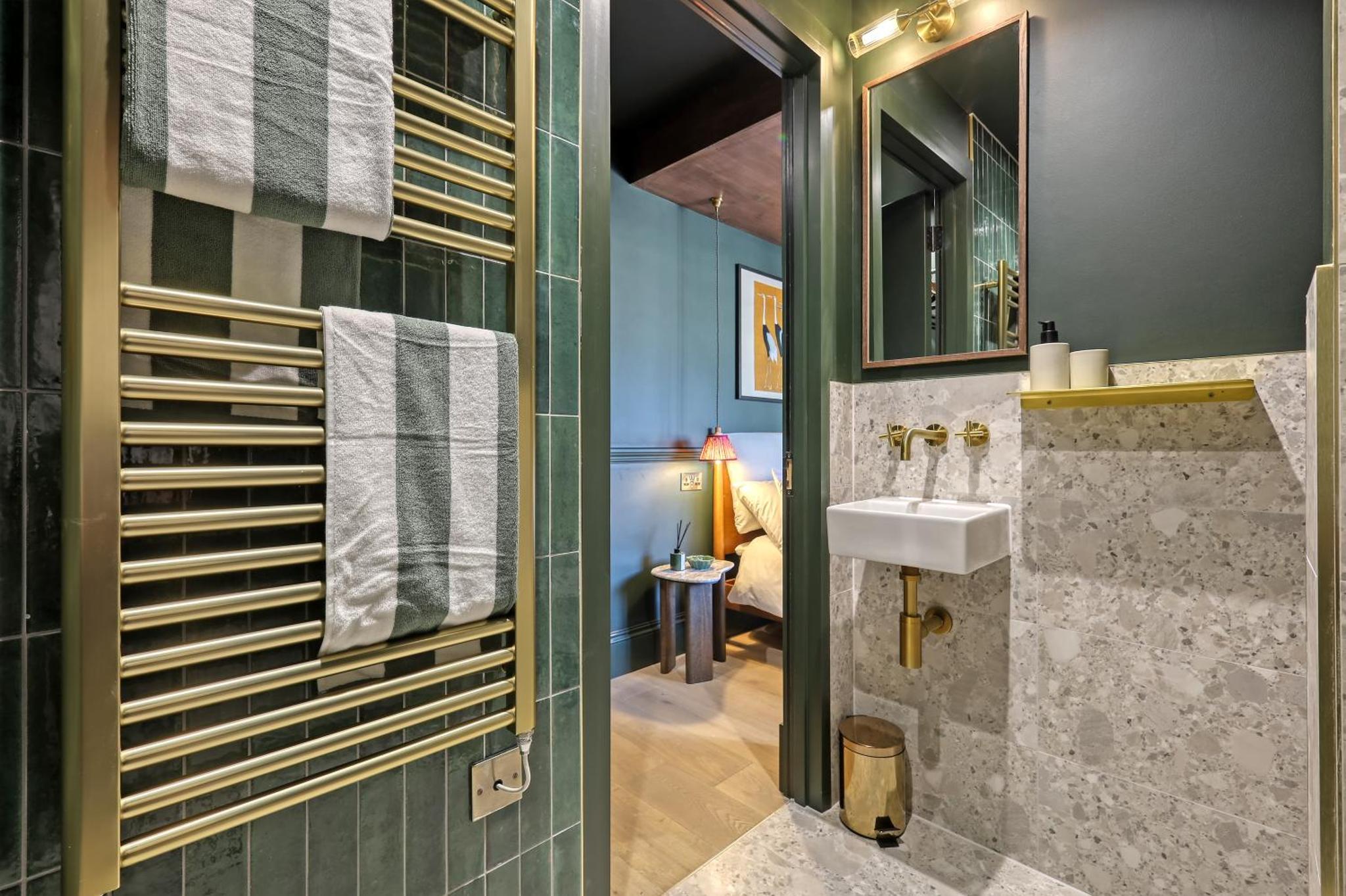 a bathroom with a sink and a mirror at The Carlton Tavern Hotel in London