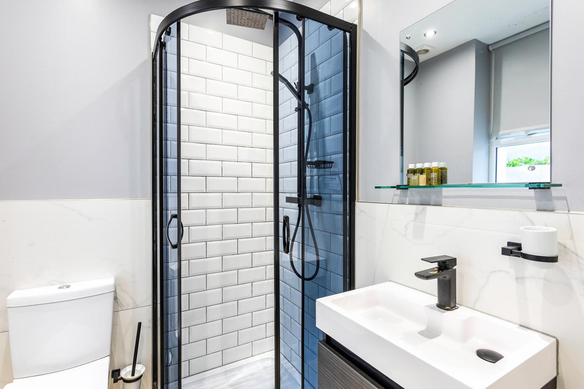 a bathroom with a sink and a shower at Bob W London Earl's Court - Warwick Road in London +17 photos
