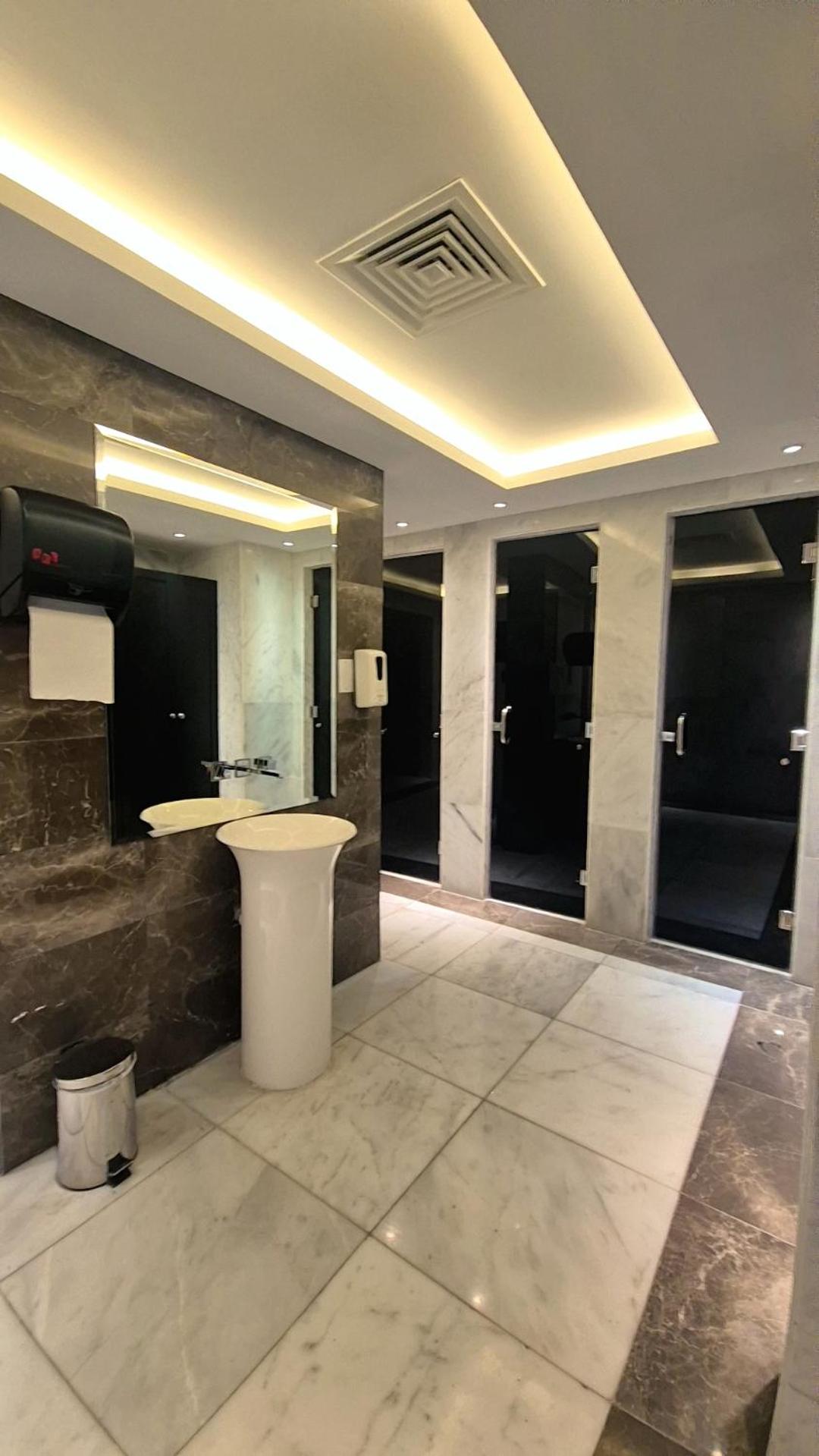 a large bathroom with a sink and a counter at Luxury Romantic Sea View Apartment-ERAإقامة هادئة إطلالة بحرية موقع استثنائي- Manama in Manama +88 photos