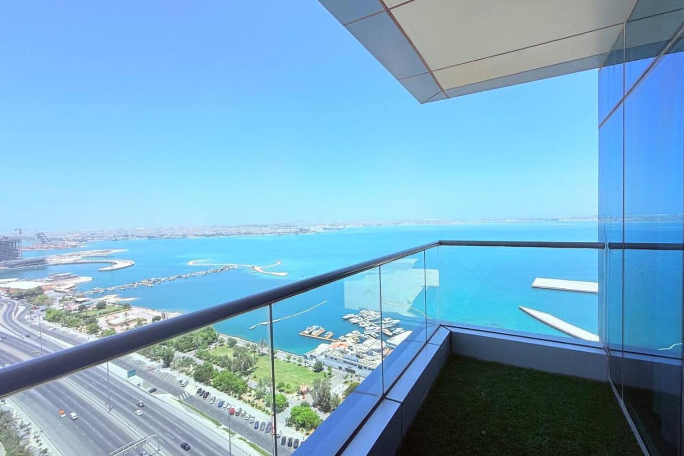 a view of the ocean from a building at Seaview White 1Br Balcony in Manama