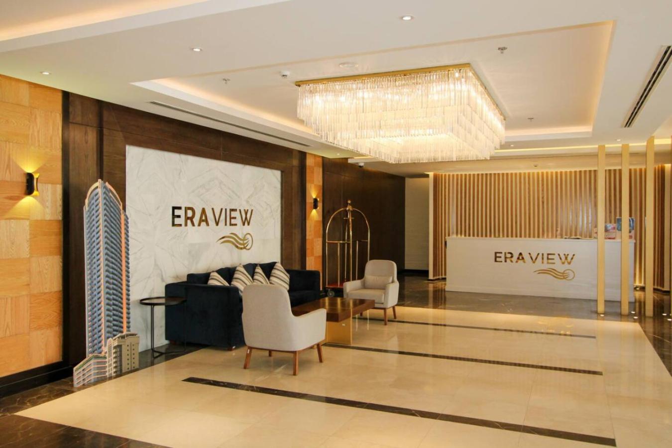 a lobby of a hotel with a couch and chairs at Seaview White 1Br Balcony in Manama +32 photos