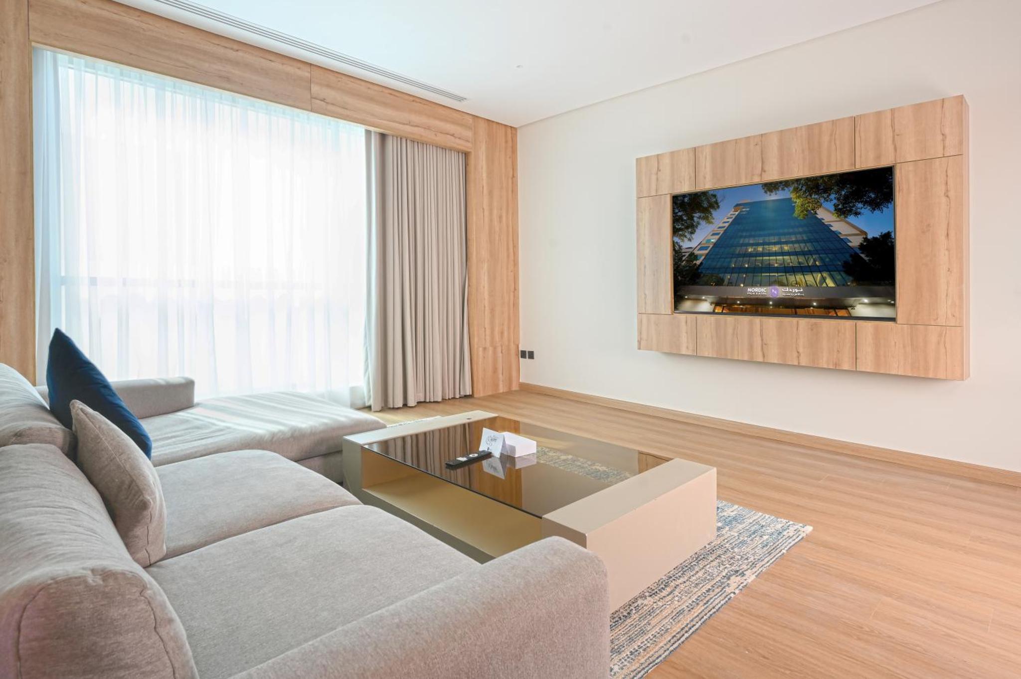 a living room with a couch and a coffee table at Nordic Palace and spa in Manama