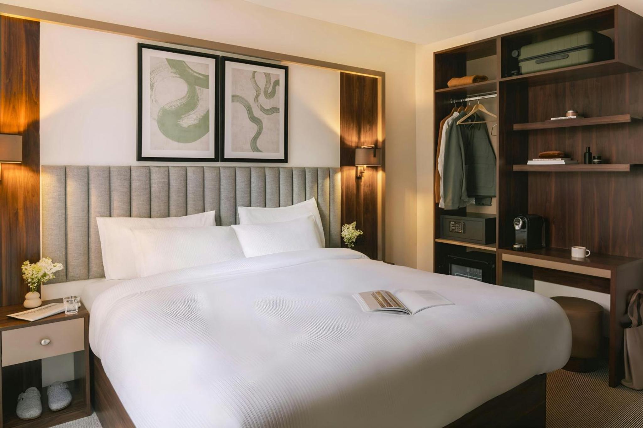 a large white bed in a hotel room at The Voyage Hotel Paddington in London +24 photos