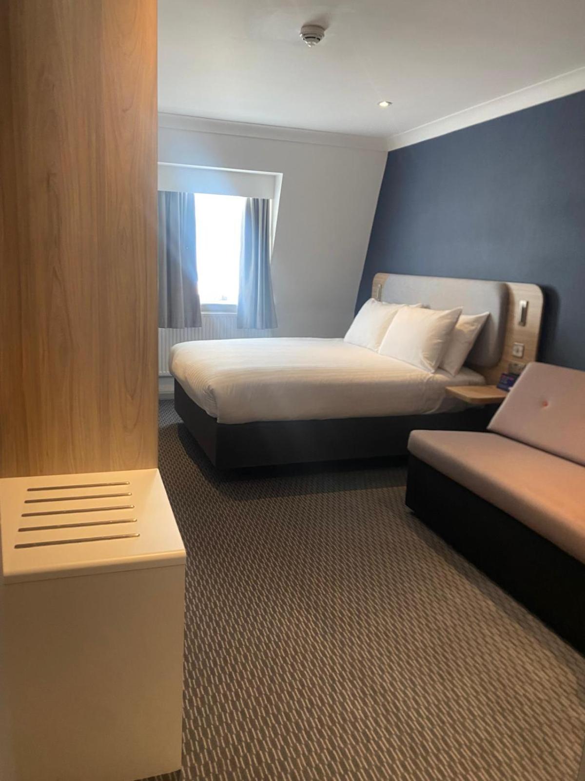 a hotel room with two beds and a window at Holiday Inn Express London Victoria by IHG in London +63 photos