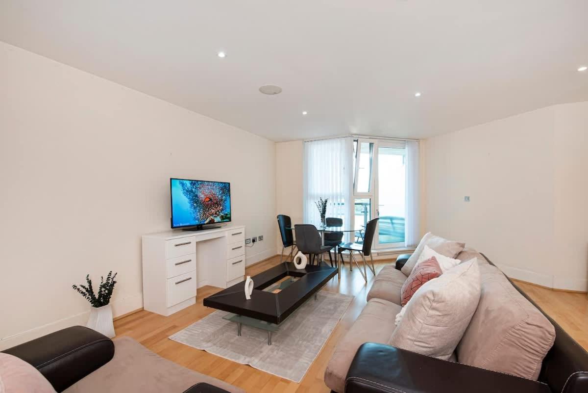 a living room with a couch and a tv at Charming 2 bed Thames view in London
