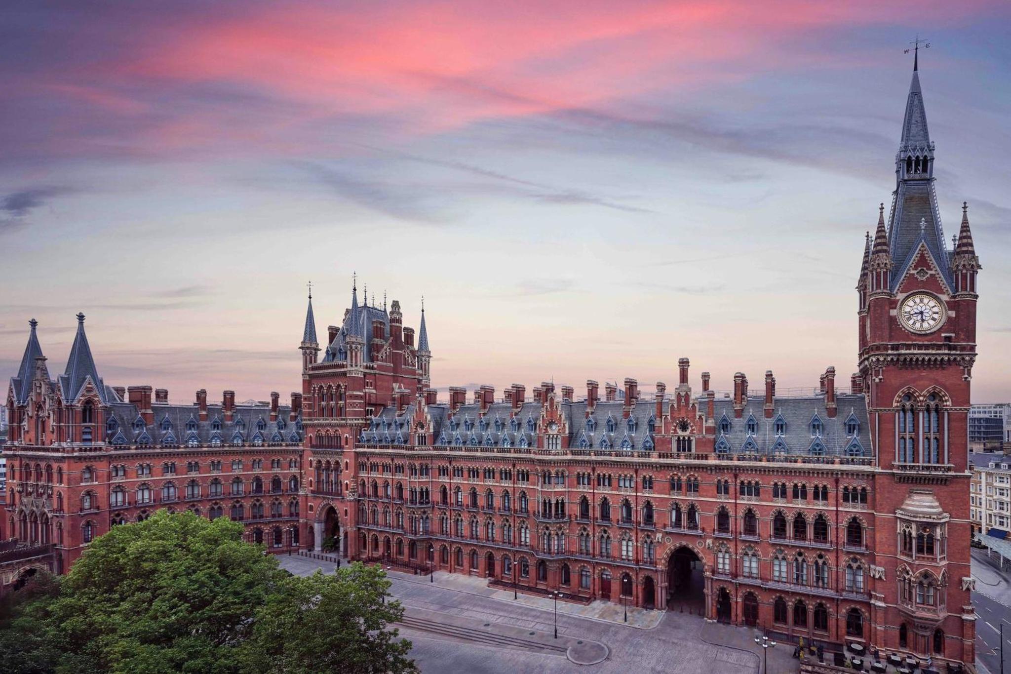 a large building with a clock tower on top of it at St Pancras London, Autograph Collection in London