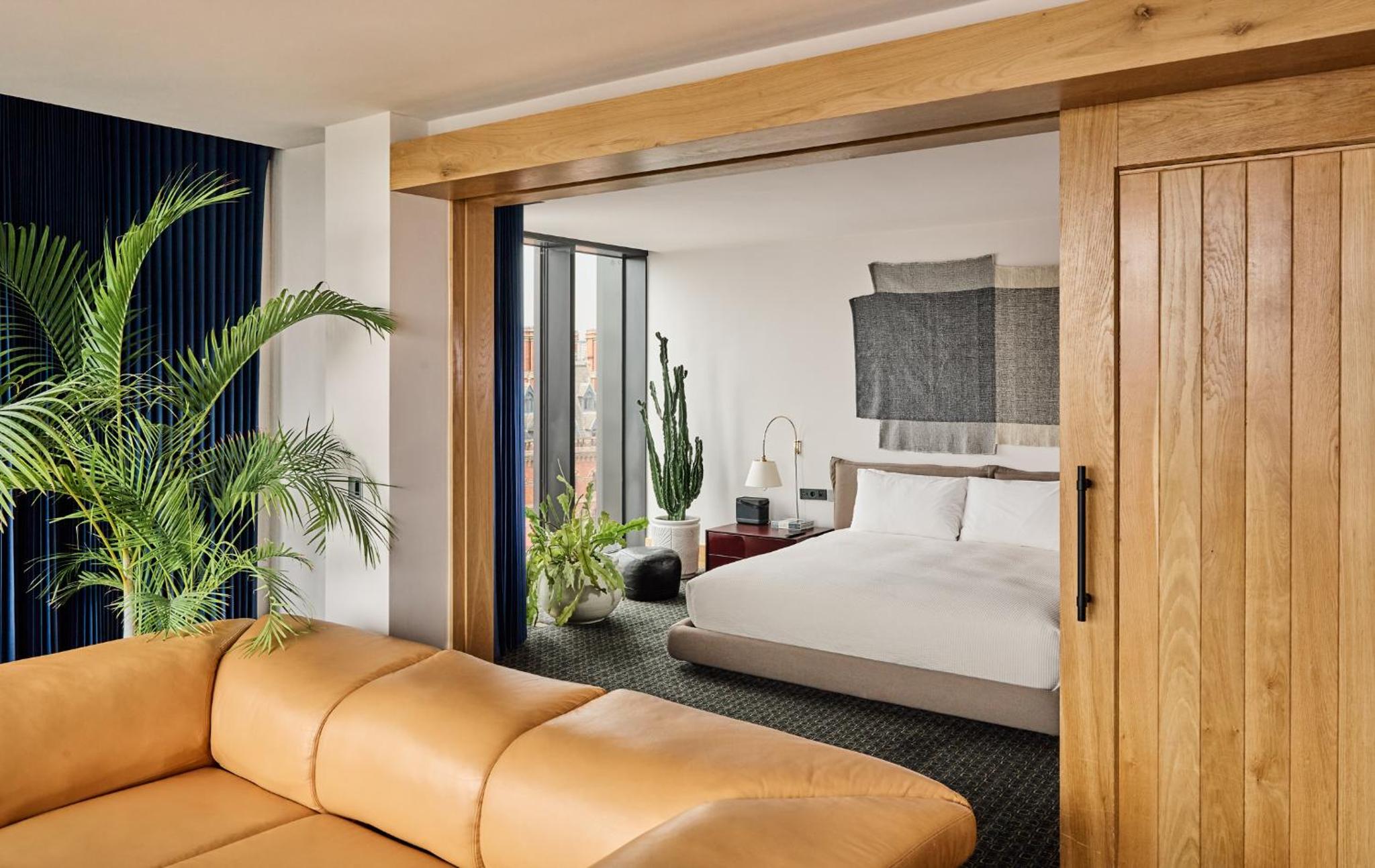 a bedroom with a bed and a couch at The Standard London in London