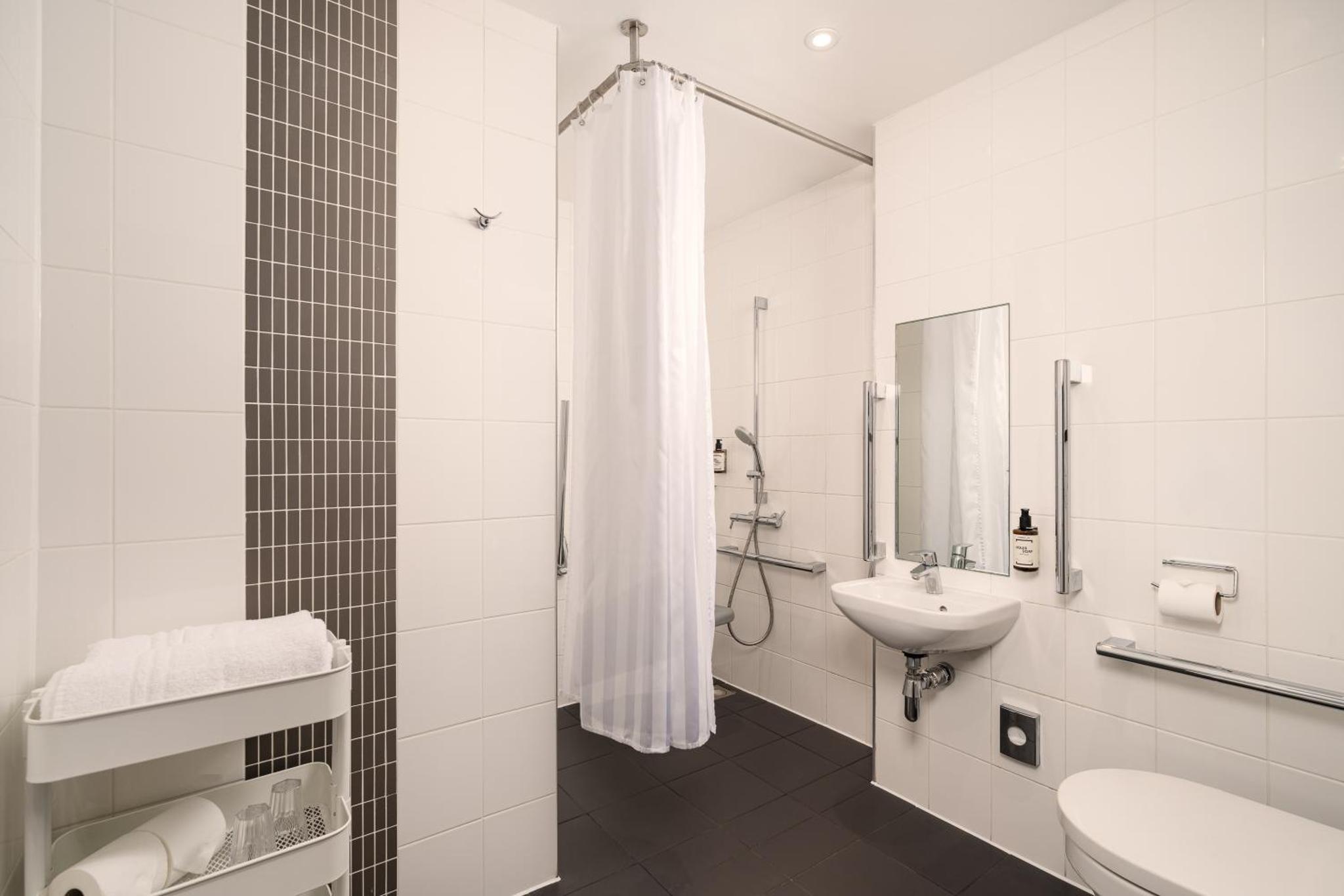a white bathroom with a sink and a toilet at Point A Hotel London Westminster in London