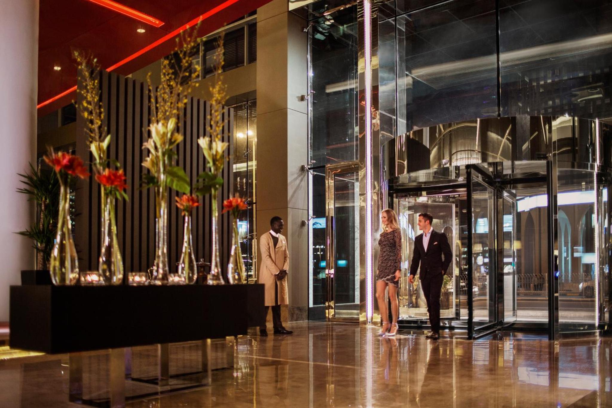 a group of three people standing in a lobby at Downtown Rotana in Manama +65 photos