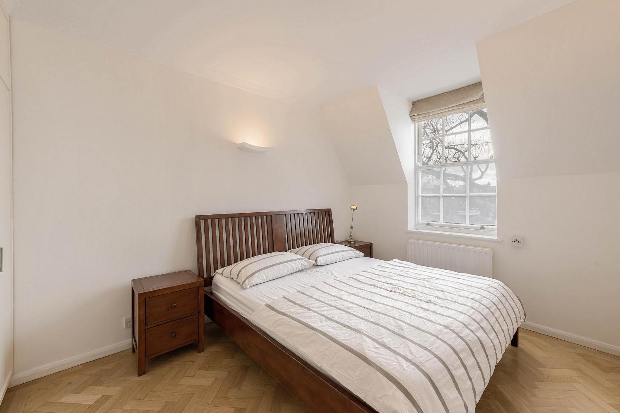 a bedroom with a large bed and a window at Top view Notting Hill Kensington in London