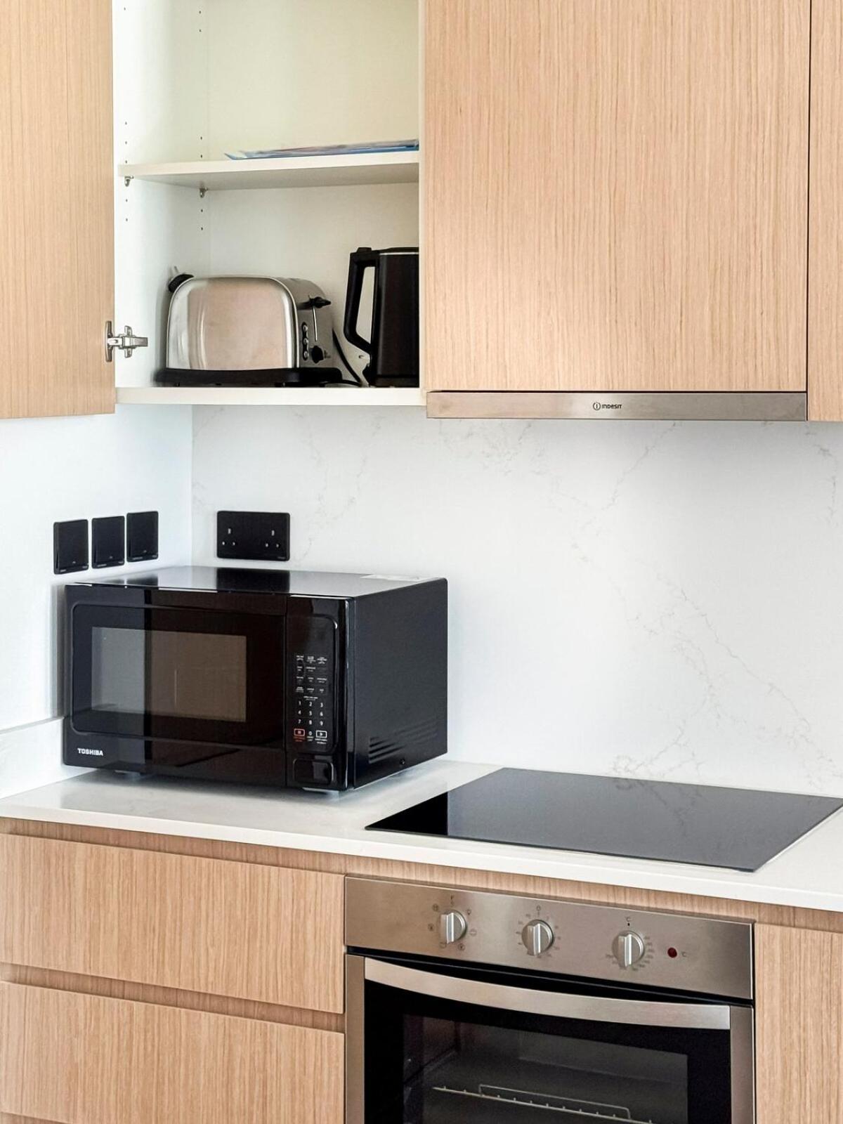 a microwave oven sitting on top of a kitchen counter at Luxurious Sea and Pool View Studio in Marassi Vista Al Bahrain in Muharraq