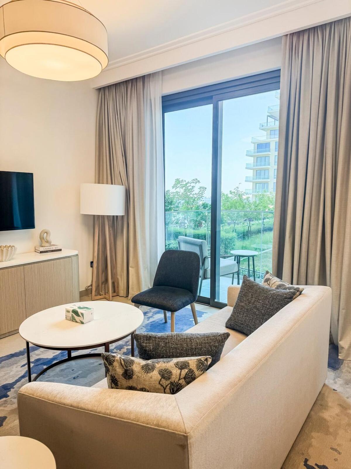 a living room with a couch and a table at Luxurious Sea and Pool View Studio in Marassi Vista Al Bahrain in Muharraq