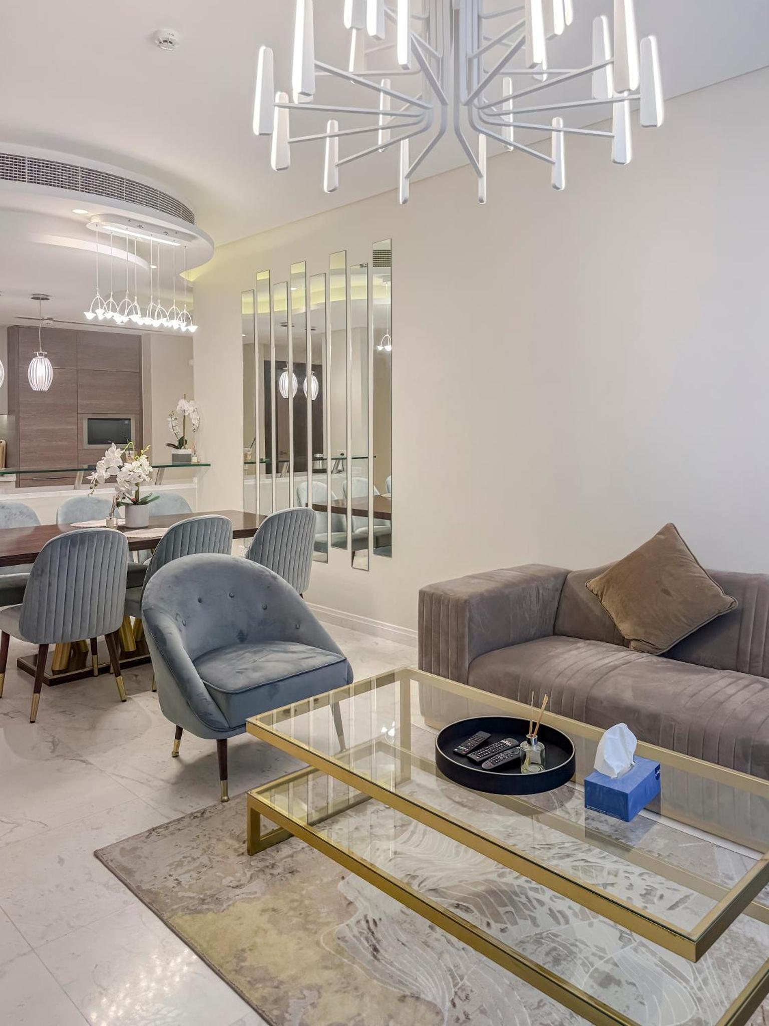 a living room with a couch and a table at Luxurious 2BR APT in Bahrain Bay in Manama