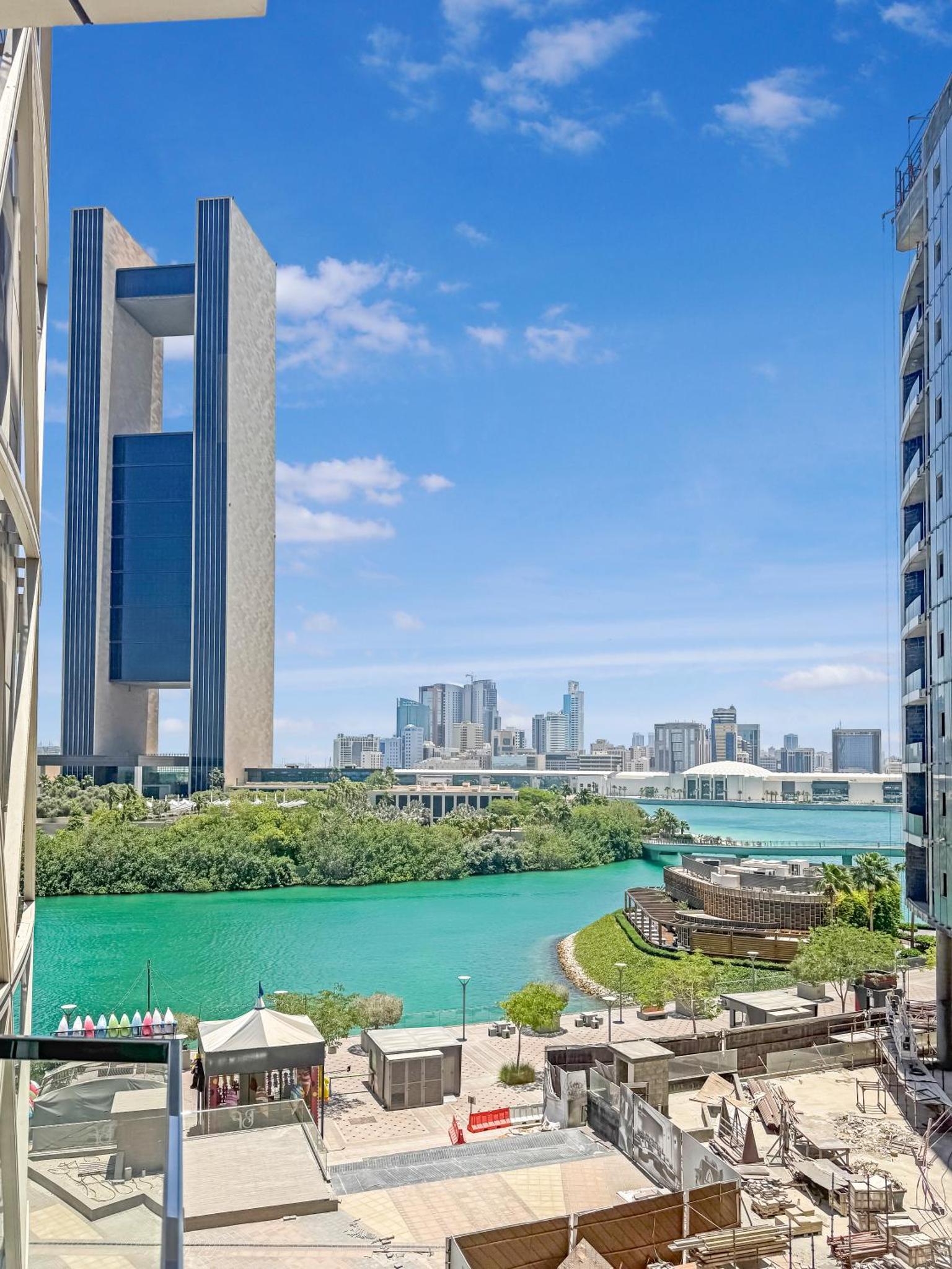 a view of a river with buildings in the background at Luxurious 2BR APT in Bahrain Bay in Manama