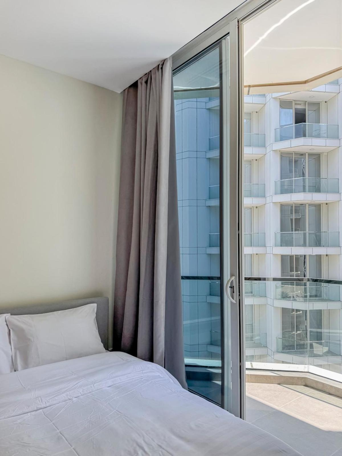 a bedroom with a bed and a large window at Cozy Studio in Bahrain Bay Waterfront in Manama +34 photos