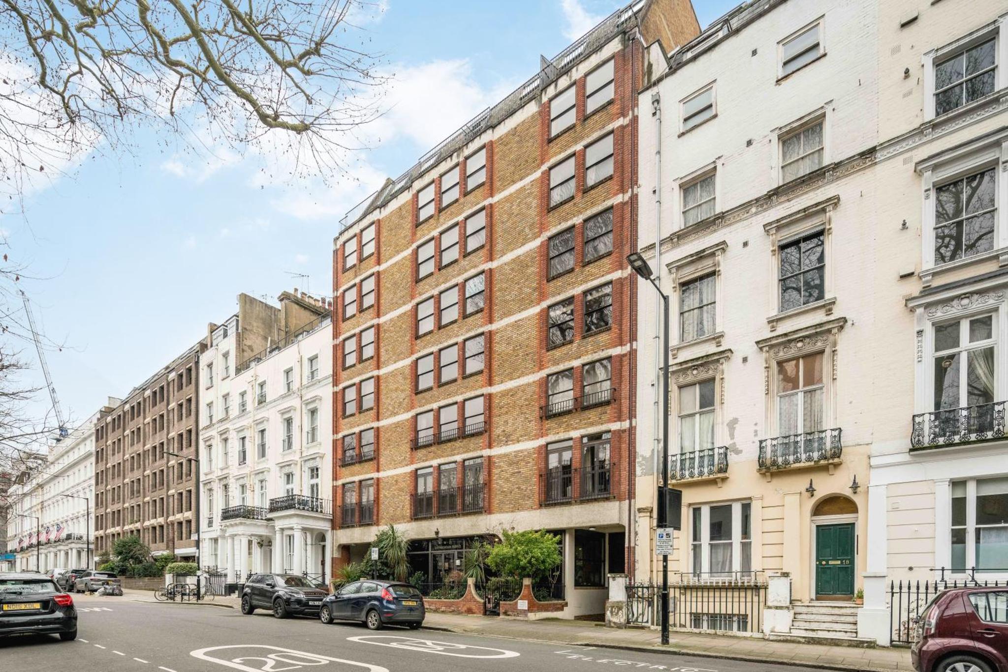 a brick building on a city street with cars parked in front at Hyde park,2 Bedrooms 2Bathrooms, Perfect for Families! 6th floor, no lift temporarily! in London