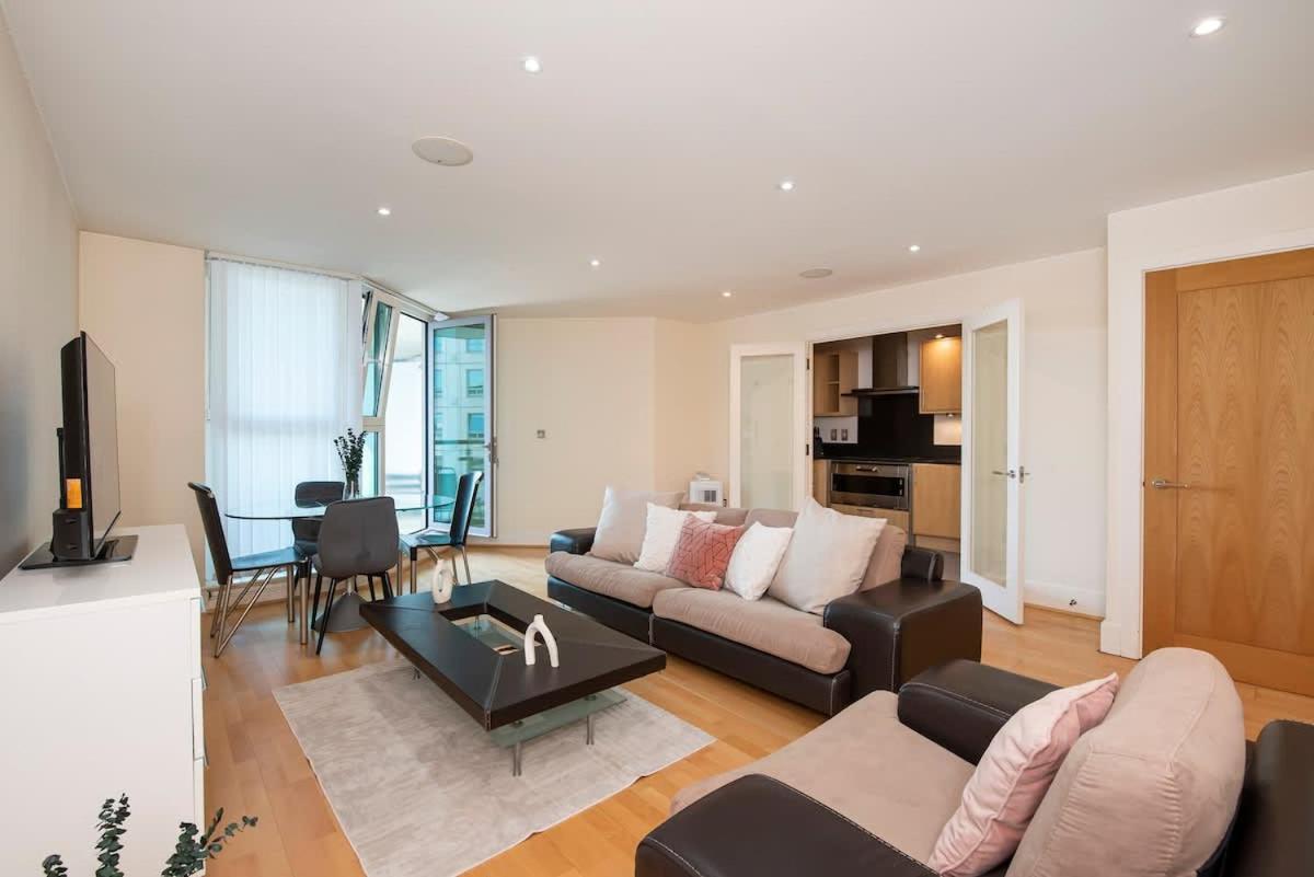 a living room with a couch and a table at Charming 2 bed Thames view in London