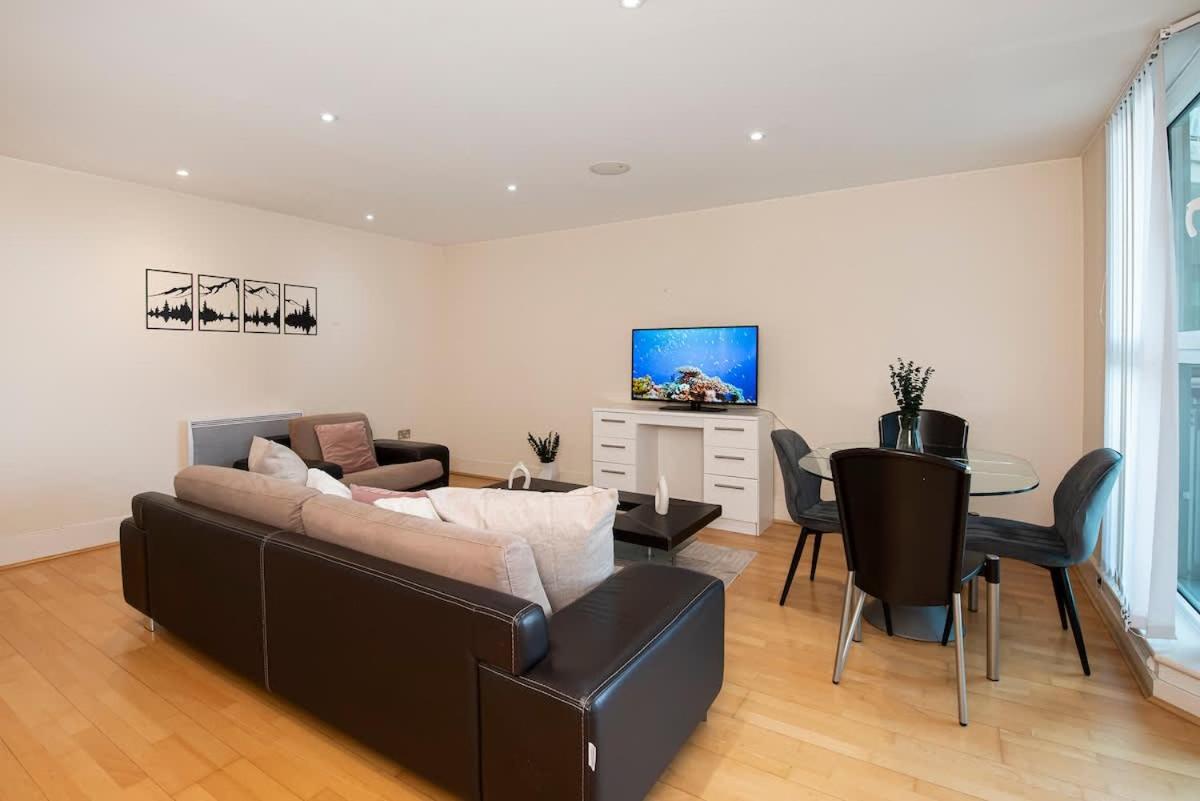 a living room with a couch and a table at Charming 2 bed Thames view in London